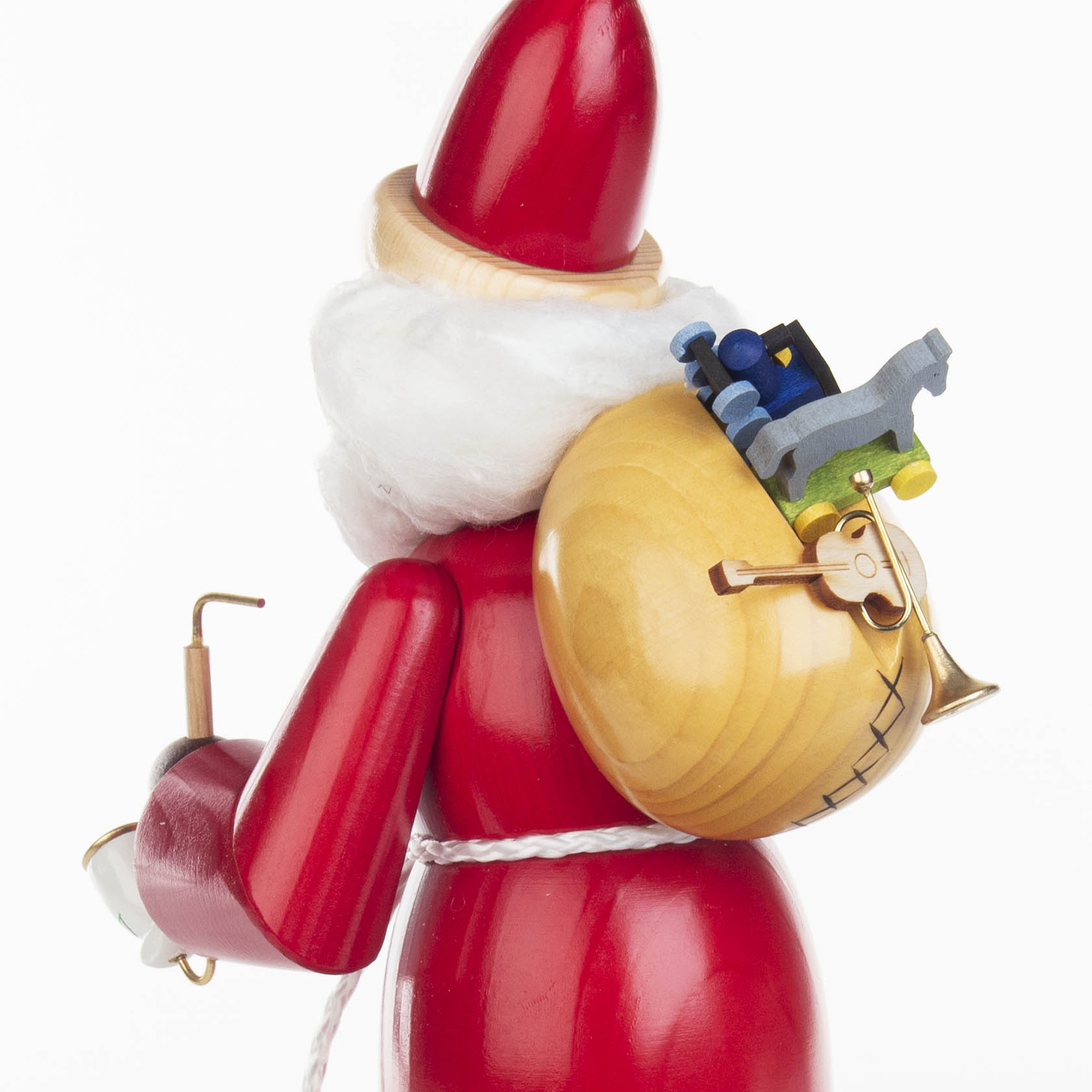 Traditional German incense smoker figurine shaped like Santa Claus, wearing a red suit and carrying a wooden sack filled with toys on his back.