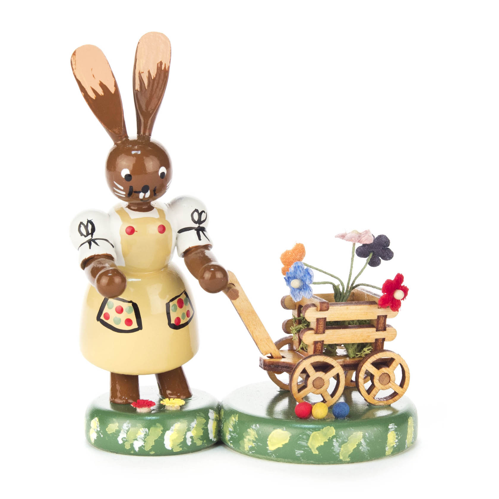 Holzfigur eines weiblichen Hasen in gelbem Kleid schiebt einen kleinen Handwagen mit bunten Blumen. im Dregeno Online Shop günstig kaufen