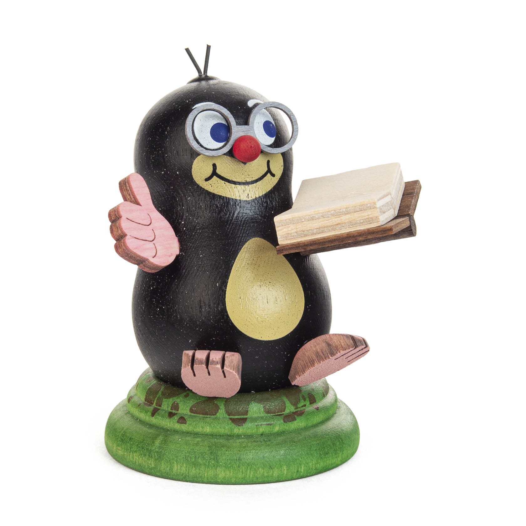 A wooden figure of a cheerful mole named Franzi, with glasses and a red nose, holding a book and giving a thumbs up. im Dregeno Online Shop günstig kaufen