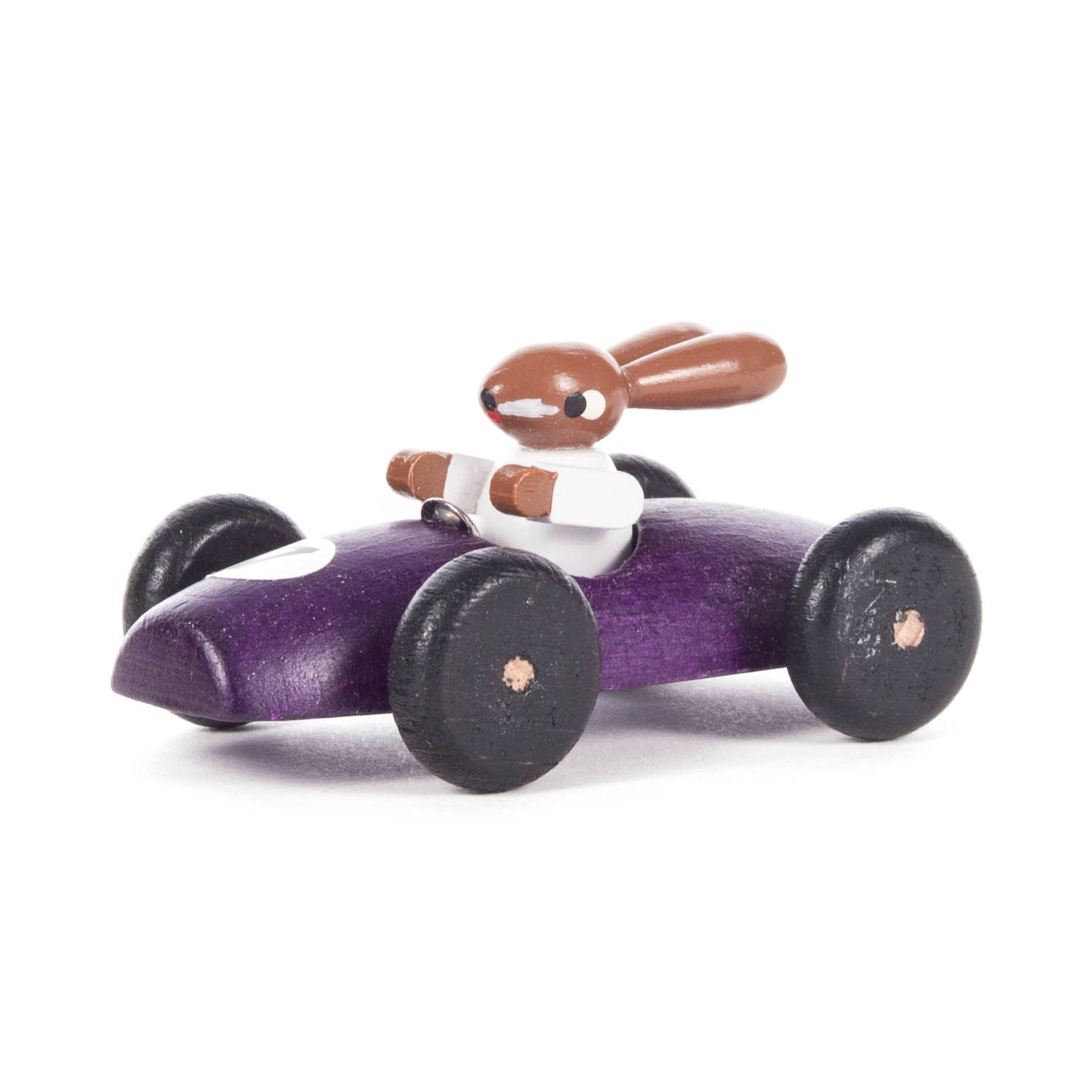 Kleines lila Rennauto mit einem Hasen als Fahrer, der eine weiße Rennanzug trägt. Schwarze Räder mit kupfernen Achsen. im Dregeno Online Shop günstig kaufen
