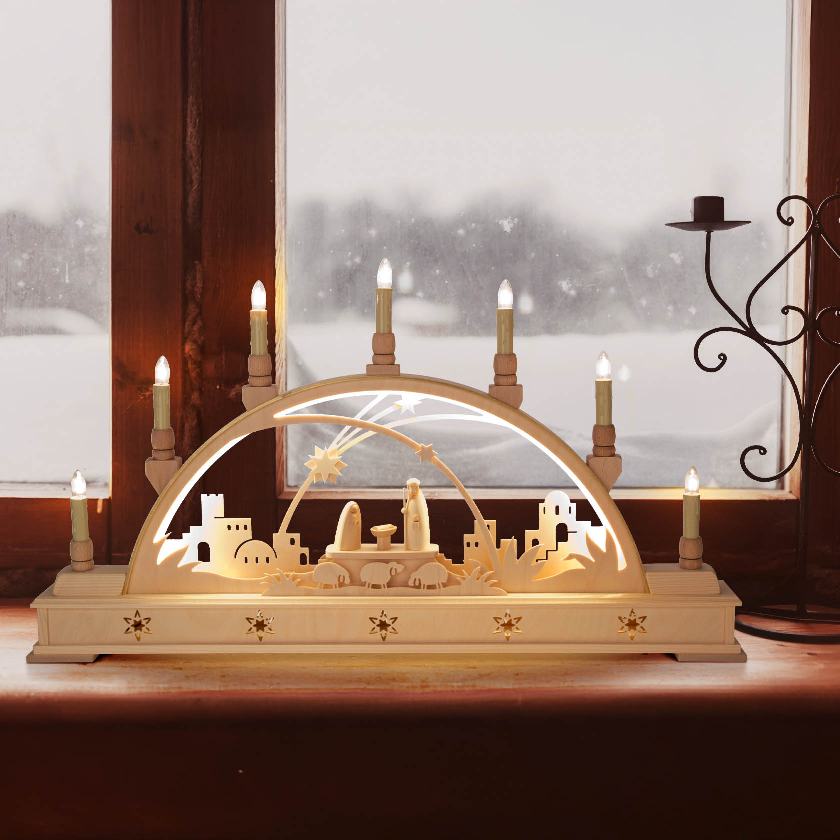 An electrically lit Schwibbogen featuring a nativity scene, with Mary, Joseph, and baby Jesus, surrounded by candle-like lights on a windowsill.