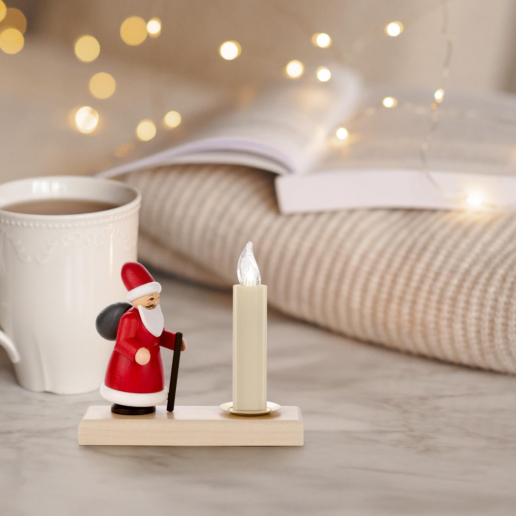 Festive candle holder featuring a colorful Ruprecht figure, designed to hold a 14mm diameter candle. The figure is dressed in red with a staff.