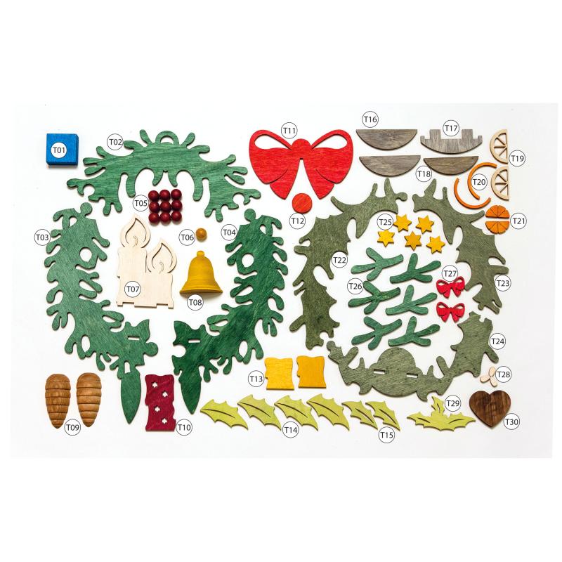 Craft kit for a door wreath, with pre-cut wooden pieces including green wreath shapes, red bow, candles, bell, and various small shapes for decoration.