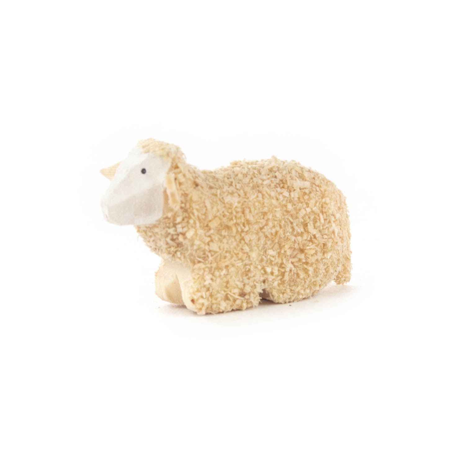 Ein aus Holz geschnitztes Schaf mit einer wolligen Textur liegt auf dem Boden. im Dregeno Online Shop günstig kaufen