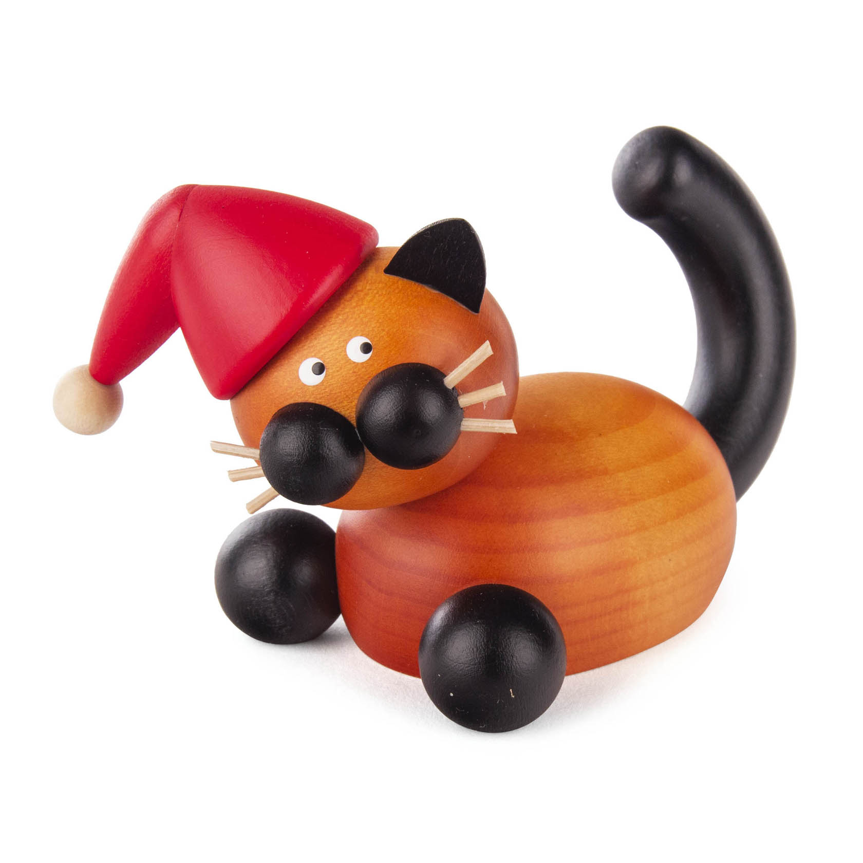 Holzfigur einer sitzenden Katze mit schwarzem Schwanz und Ohren, großen runden Augen und einer roten Weihnachtsmütze mit Bommel. im Dregeno Online Shop günstig kaufen
