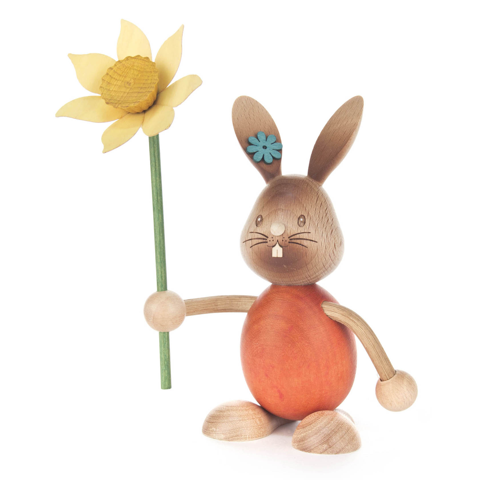 Holzfigur eines Hasen namens Stupsi mit orangefarbenem Körper, der eine gelbe Blume mit grünem Stiel hält. im Dregeno Online Shop günstig kaufen