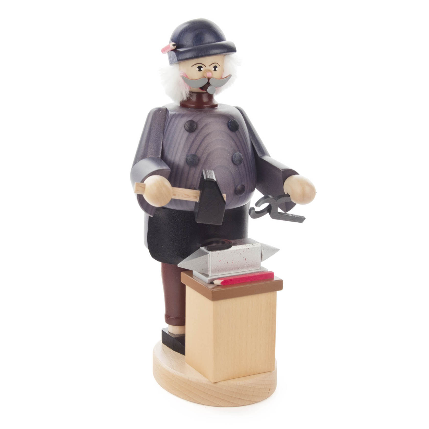 Holzfigur eines Schmieds mit Schnauzbart, blauem Helm und schwarzem Mantel. Hält einen Hammer in der Hand und steht vor einem Amboss auf einem Holzsockel. im Dregeno Online Shop günstig kaufen