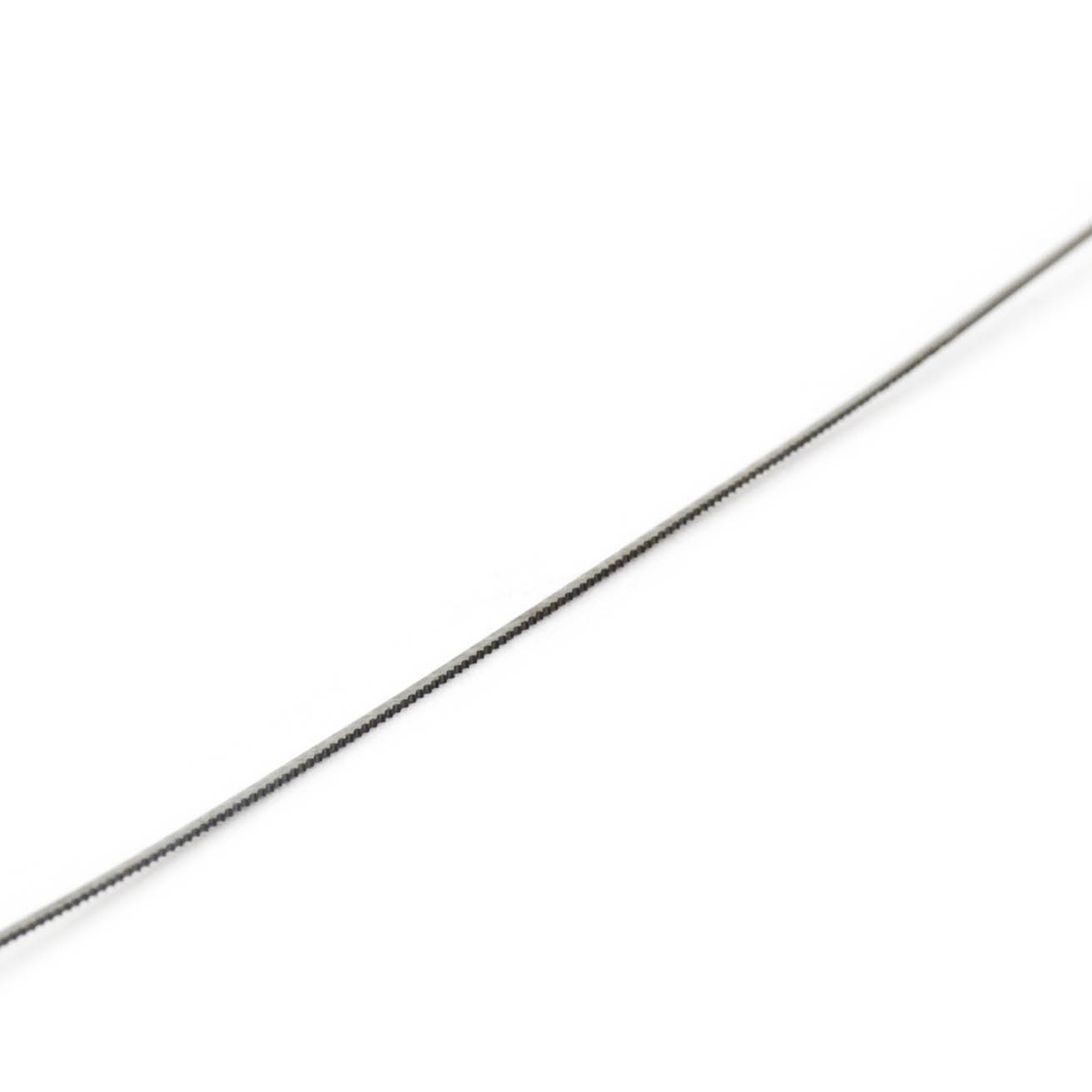 Close-up of a single, thin fret saw blade with small teeth, designed for cutting wood.