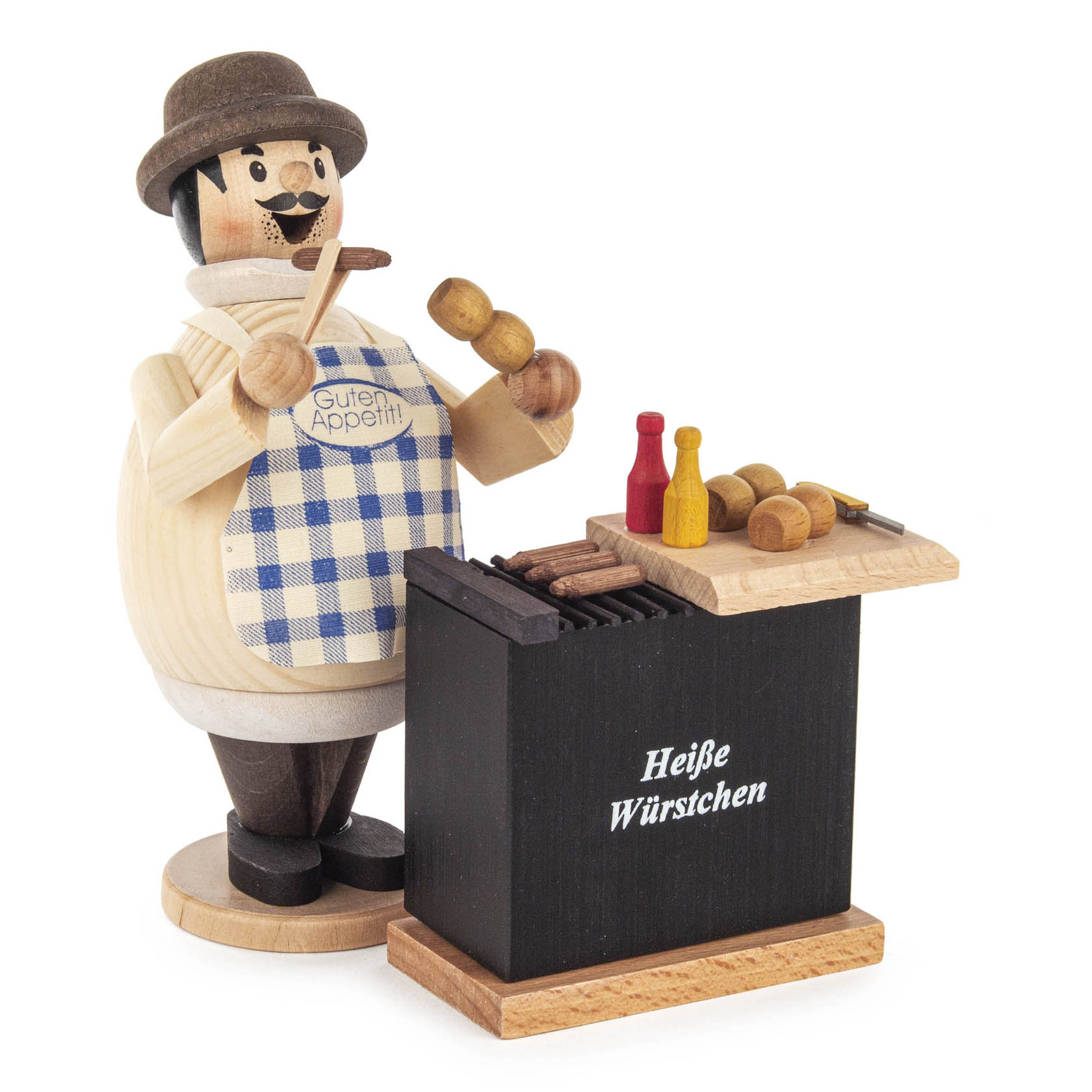 A wooden figure, Rauchermann Wurstmax, smiling and wearing a blue checkered apron with 'Guten Appetit' printed on it, holding a sausage near a grill labeled 'Heiße Würstchen'. im Dregeno Online Shop günstig kaufen