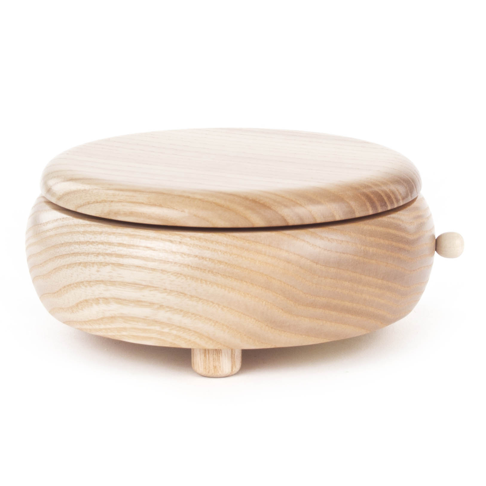 Runde, naturbelassene Holz-Spieldose ohne Dekoration, mit kleinem Drehknopf und drei kurzen Standfüßen. im Dregeno Online Shop günstig kaufen