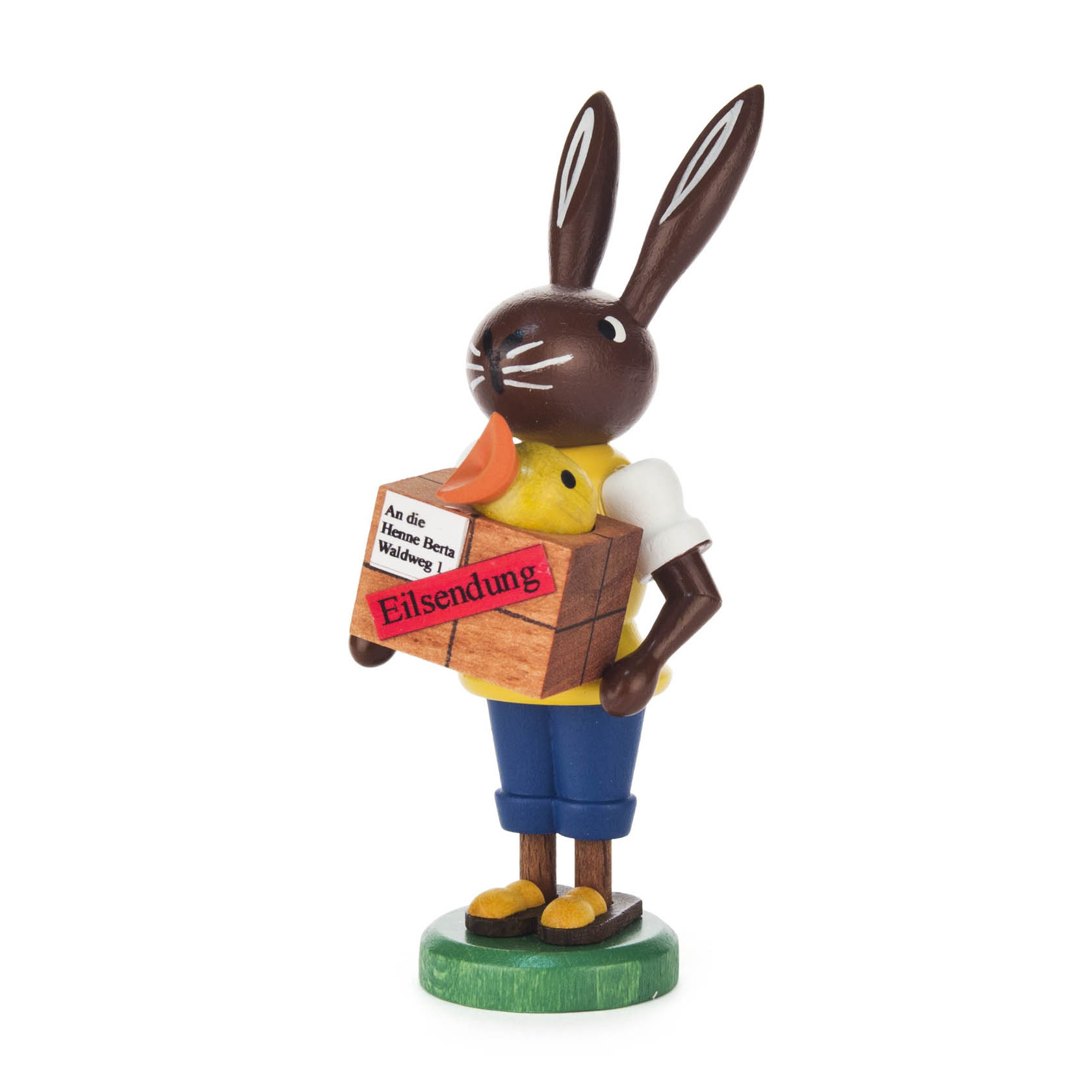 Holzfigur eines Hasen als Postbote, der ein Paket mit der Aufschrift 'Eilsendung' und einem gelben Küken darin hält. im Dregeno Online Shop günstig kaufen