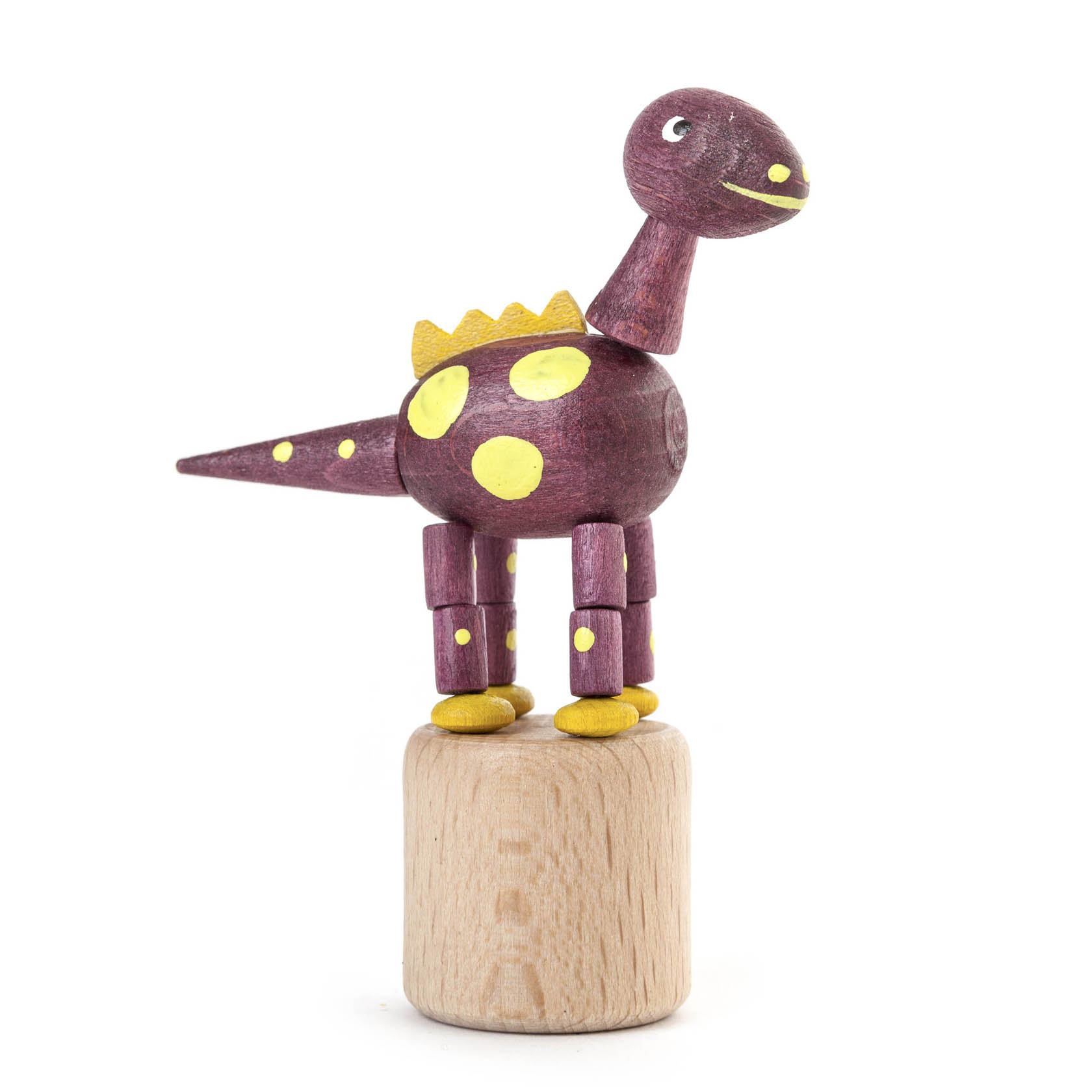Violetter Dinosaurier aus Holz mit gelben Punkten und Krone, steht auf einem Holzdruckknopf-Sockel. Beine und Hals sind beweglich. im Dregeno Online Shop günstig kaufen
