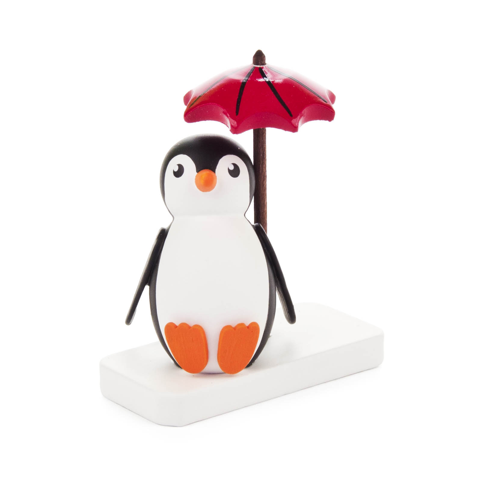 Ein sitzender Pinguin mit einem roten Schirm auf einer weißen Basis. im Dregeno Online Shop günstig kaufen
