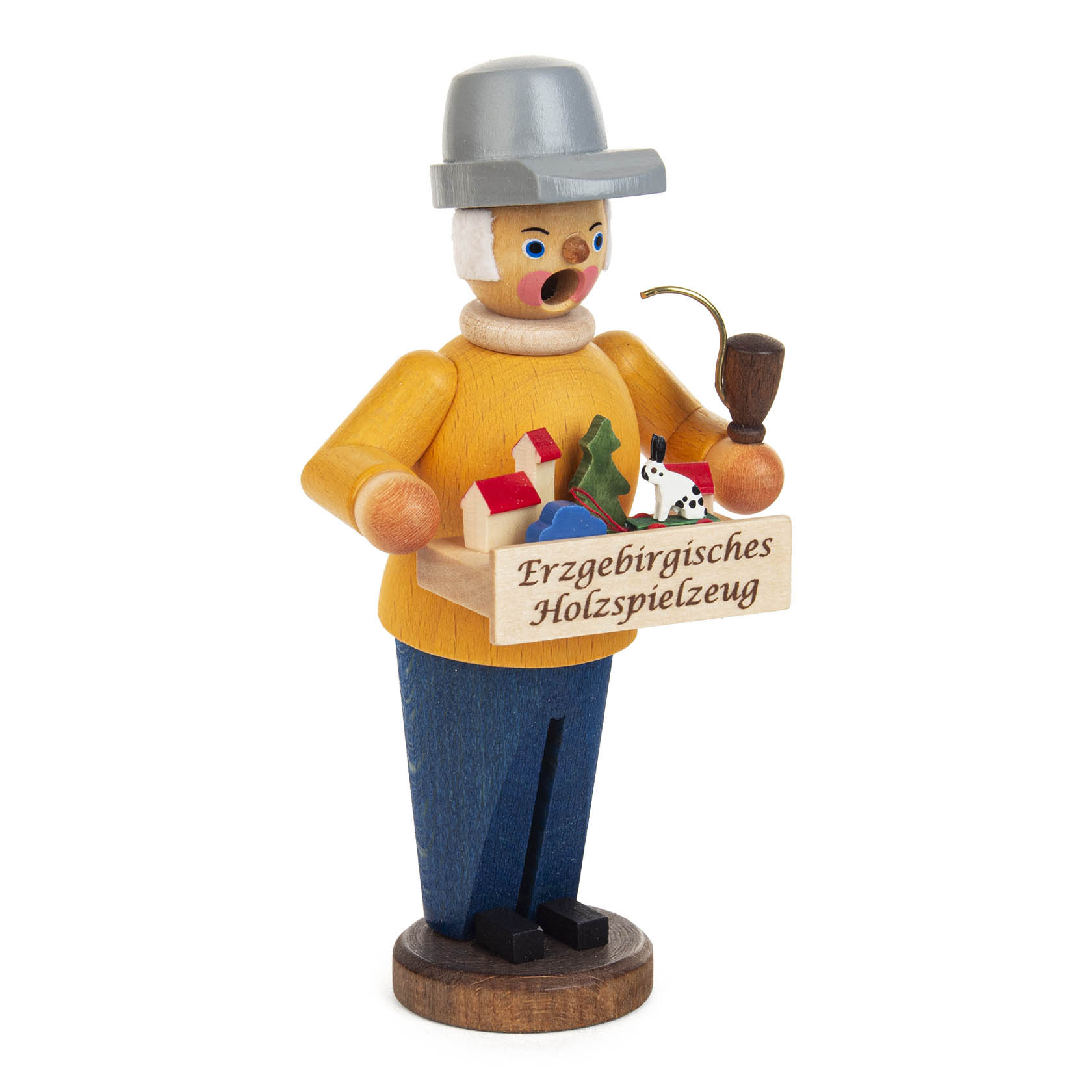 Mini-Räuchermann, der als Spielzeughändler verkleidet ist, hält eine Kiste mit buntem Spielzeug, einschließlich Reifentiere, und trägt eine Pfeife.