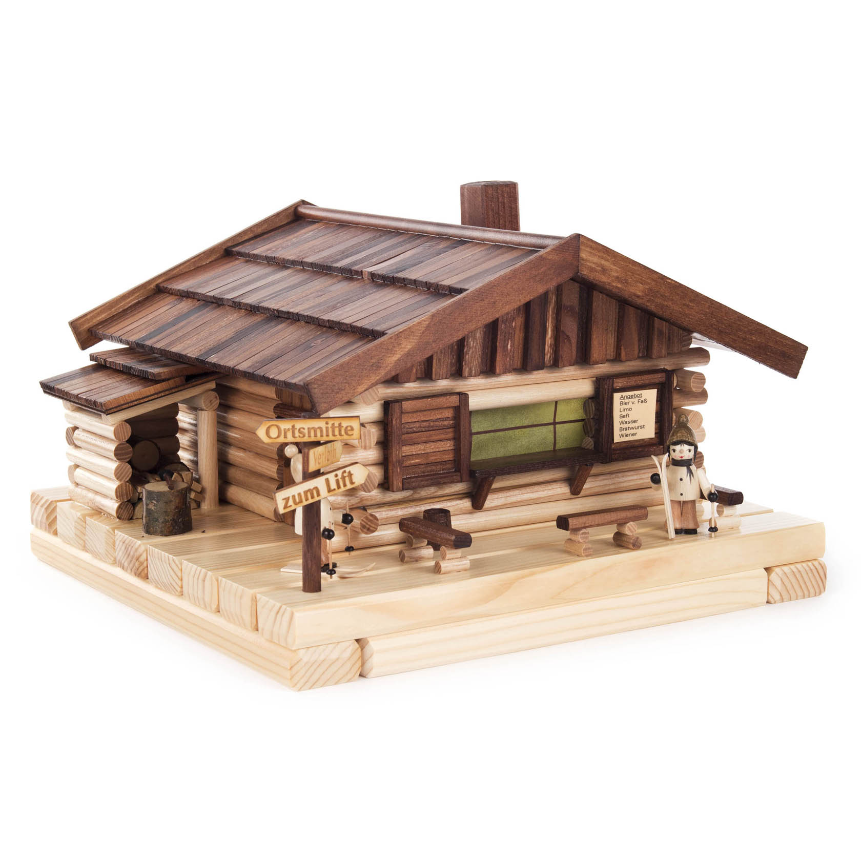 Holzskihütte mit elektrischer Beleuchtung, darauf ein Skifahrer und zwei Wegweiser zur Orstmitte und zum Lift. Dekorative Holzscheite an der Hütte. im Dregeno Online Shop günstig kaufen