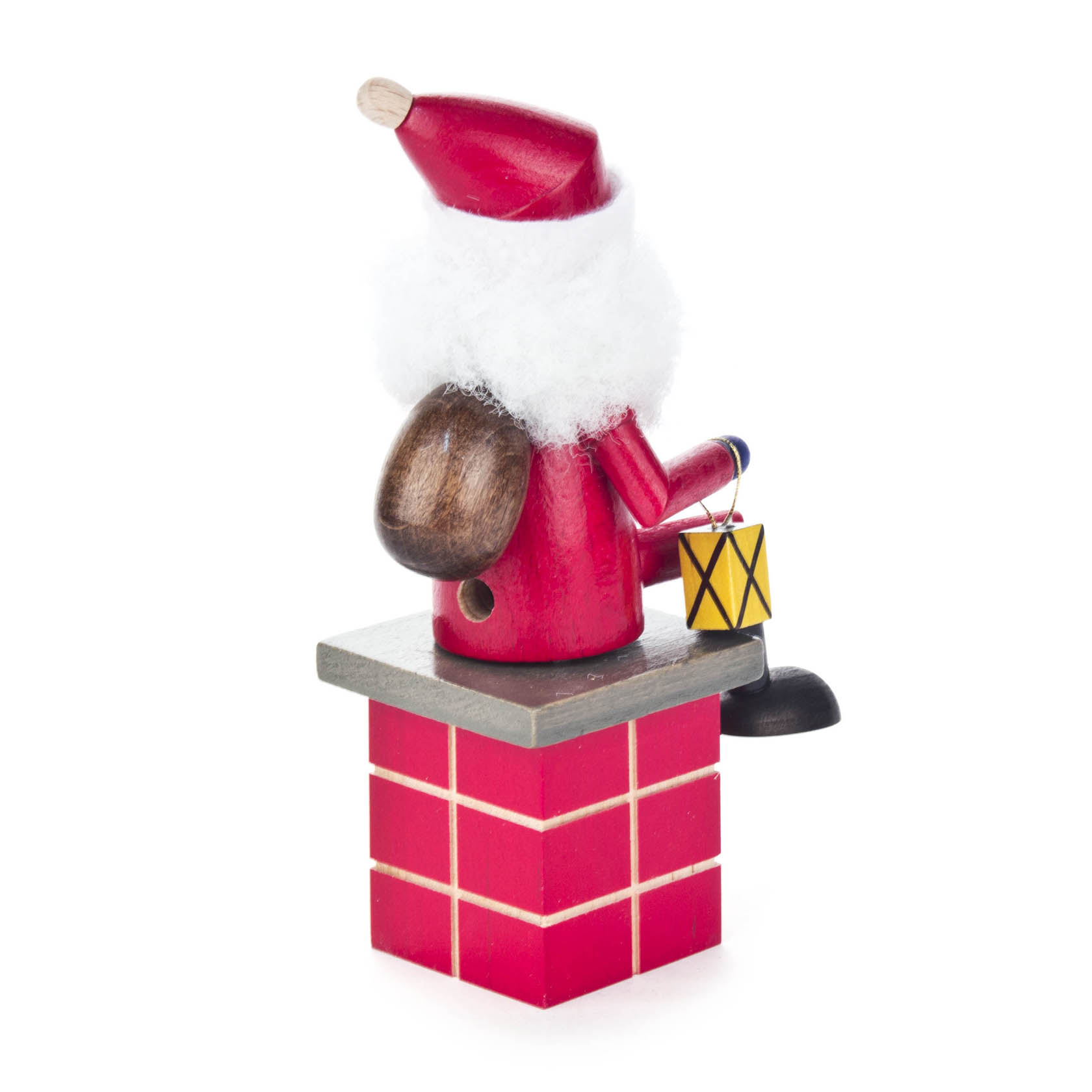 Ein Mini-Räuchermann in Form eines Weihnachtsmanns sitzt auf einem roten Schornstein. Er trägt eine rote Jacke, einen roten Hut und hält eine Laterne.