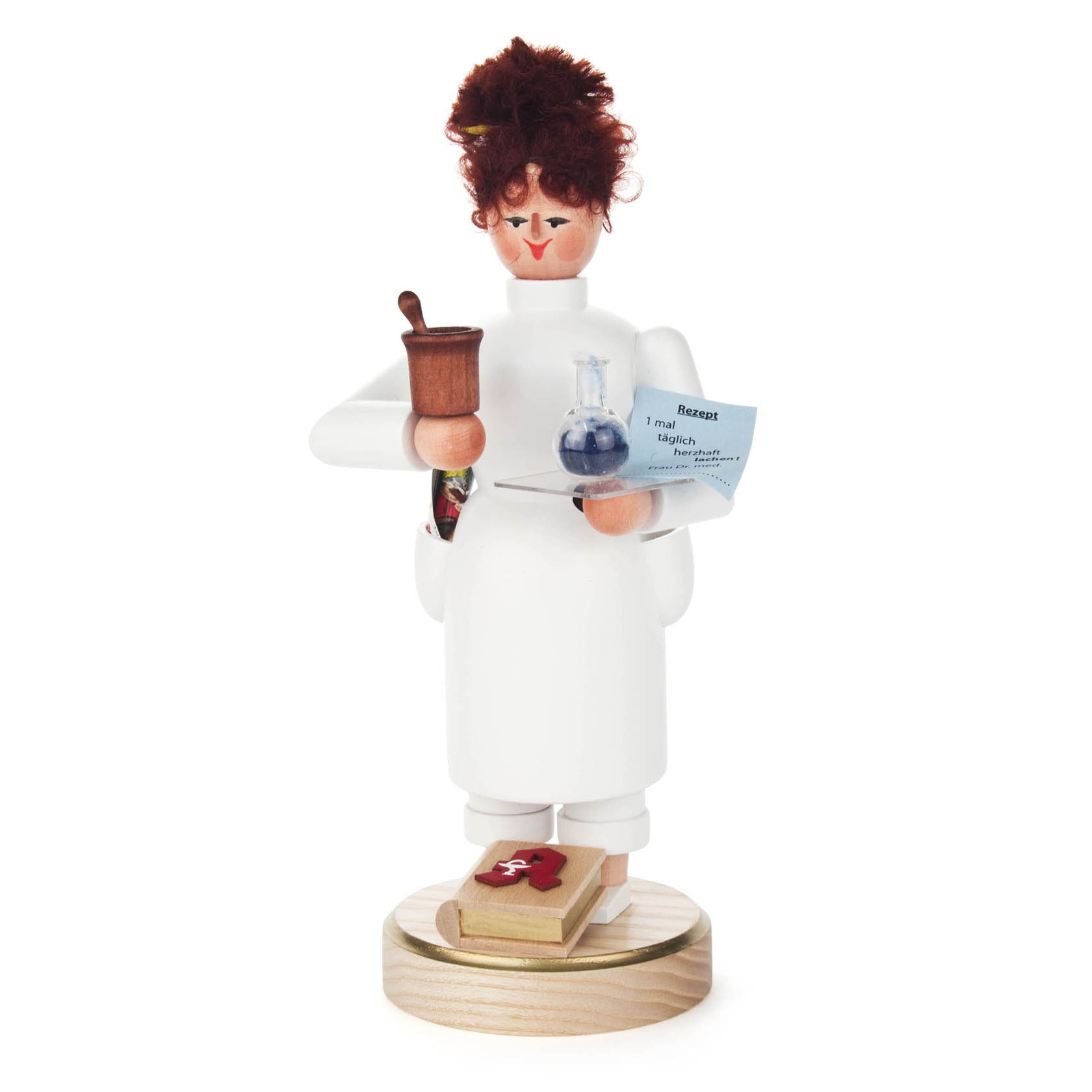 A wooden figurine of a female pharmacist, dressed in a white lab coat. She holds a mortar and pestle in one hand and a tray with a potion in the other. im Dregeno Online Shop günstig kaufen