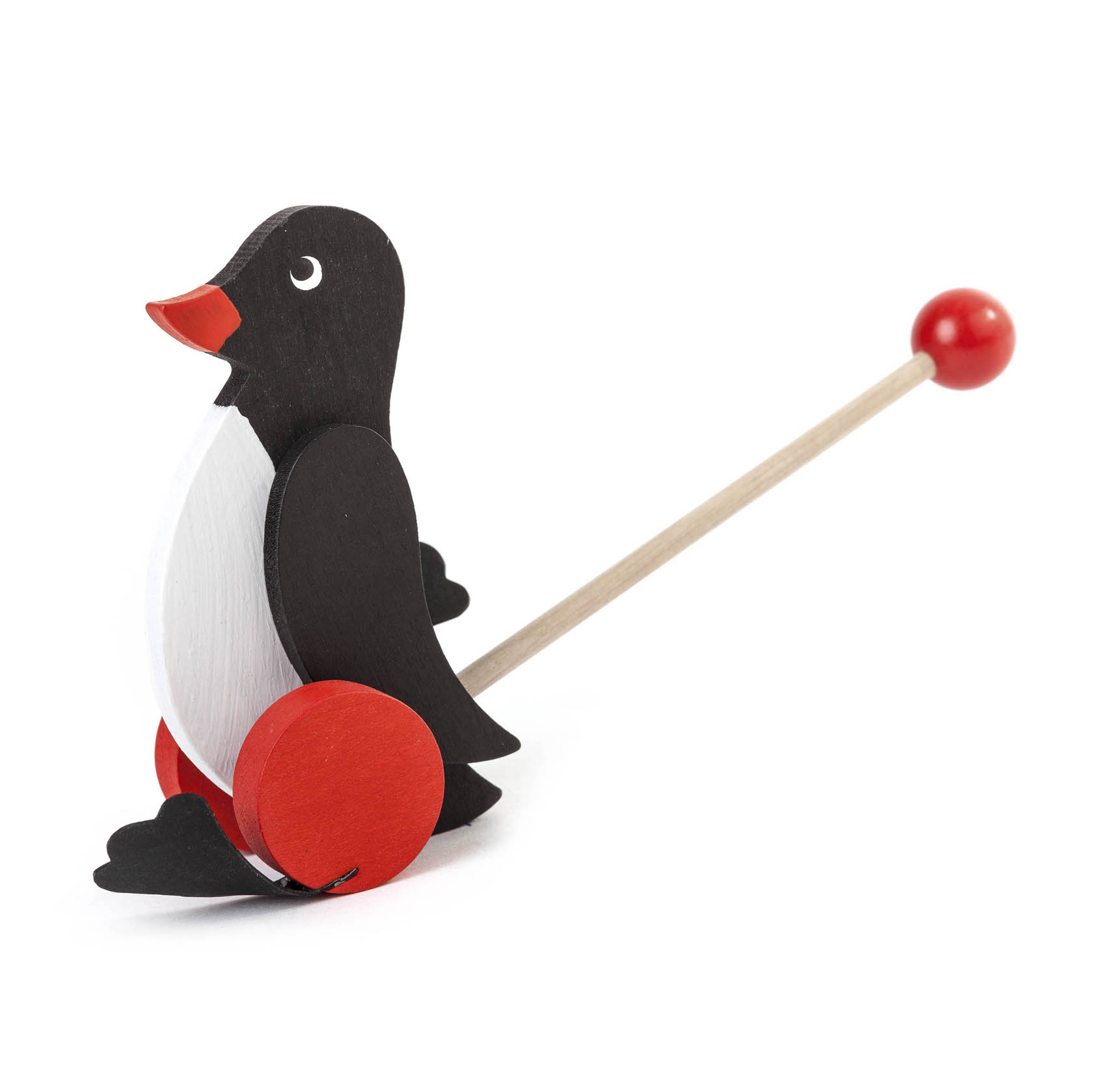 Ein Holzspielzeug in Form eines Pinguins mit schwarzem Körper, weißem Bauch und roten Akzenten. Es hat einen Stab mit einer roten Kugel zum Schieben. im Dregeno Online Shop günstig kaufen