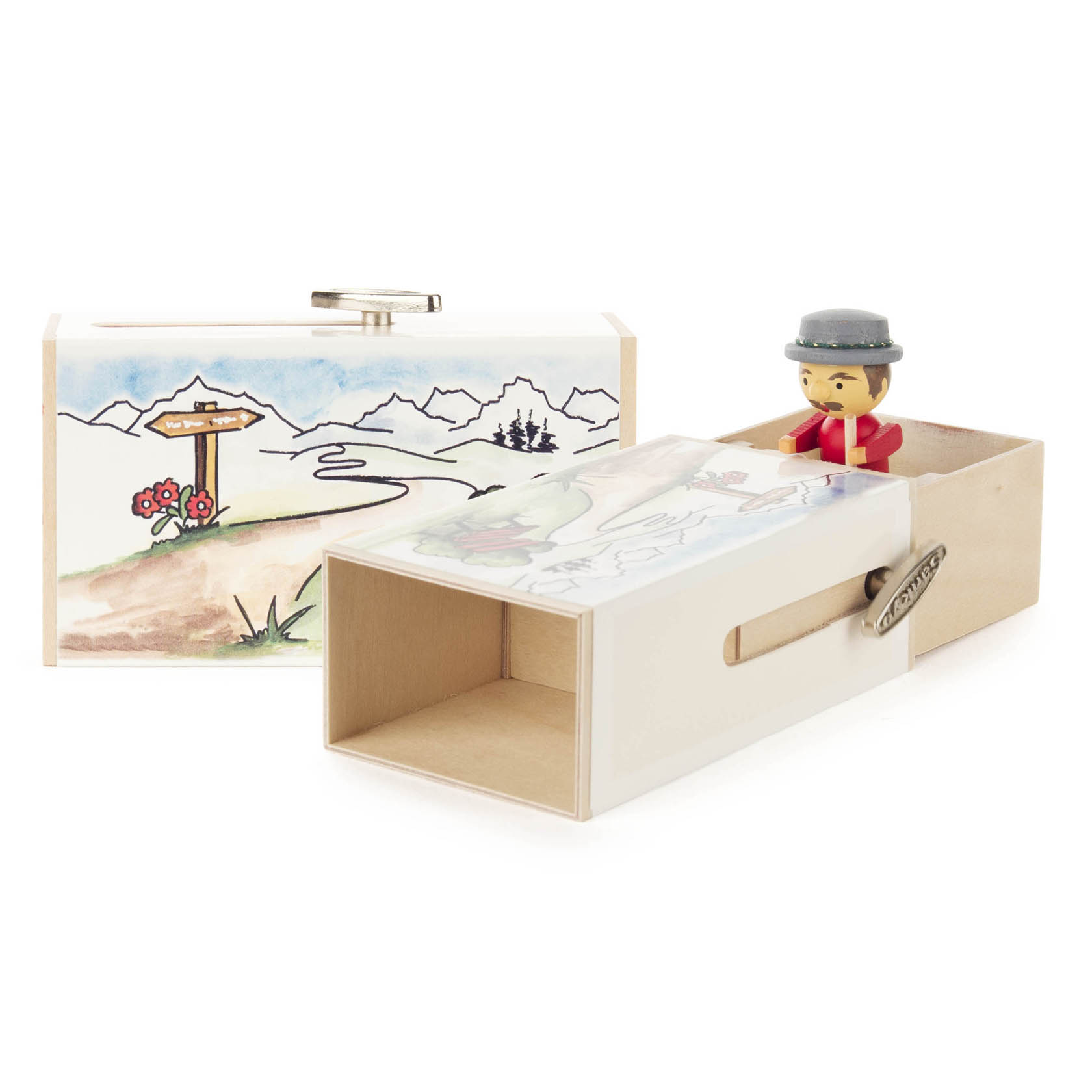 Holzschiebebox 'Bergsteigerbox' mit aufgemaltem Alpenmotiv und einer Schublade, die eine Melodie spielt. Eine Bergsteigerfigur aus Holz ragt aus der geöffneten Schublade. im Dregeno Online Shop günstig kaufen