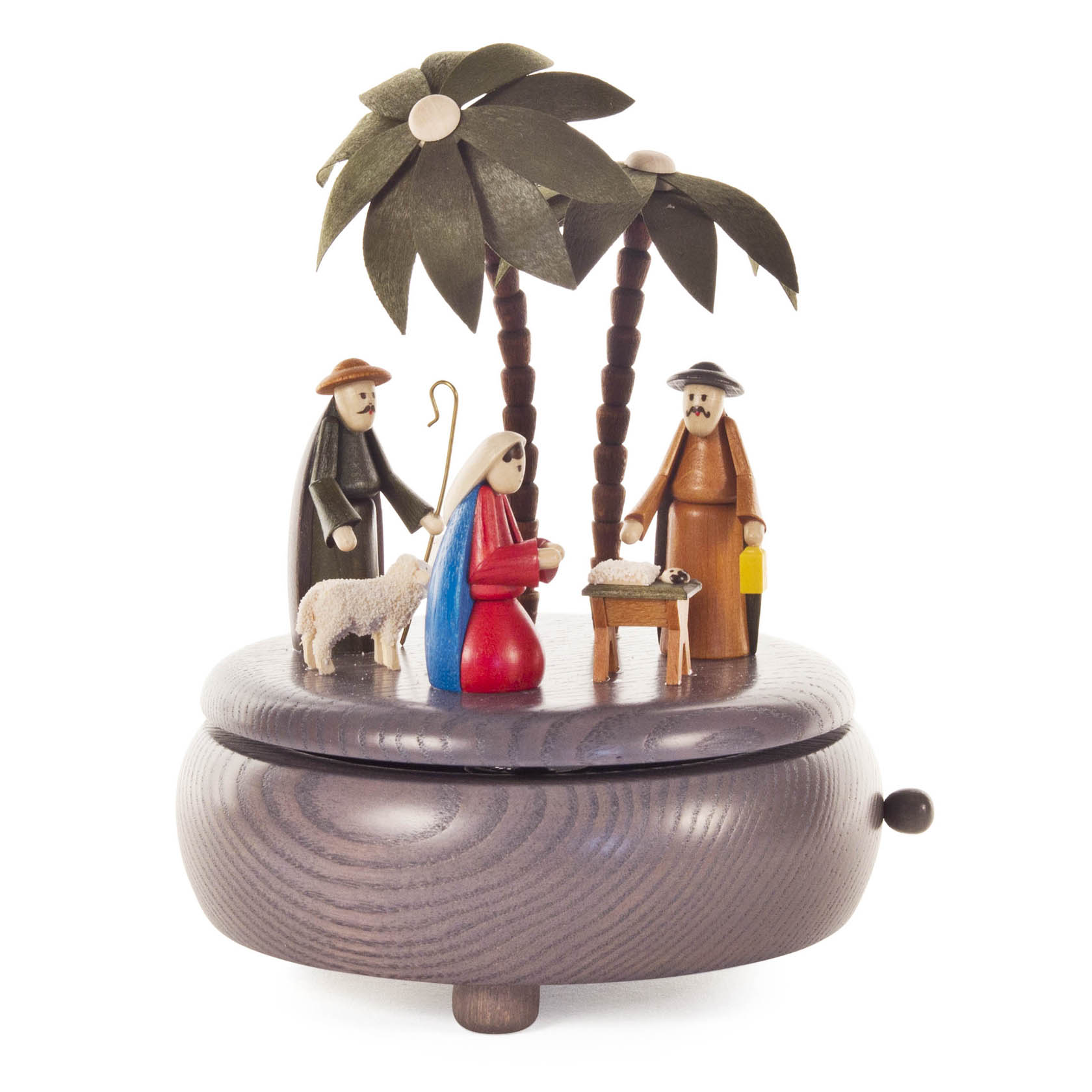 Eine graue Spieldose mit einer Darstellung der Geburt Christi. Zu sehen sind Maria, Josef, Jesus in der Krippe, ein Schäfer und ein Schaf unter Palmen. im Dregeno Online Shop günstig kaufen