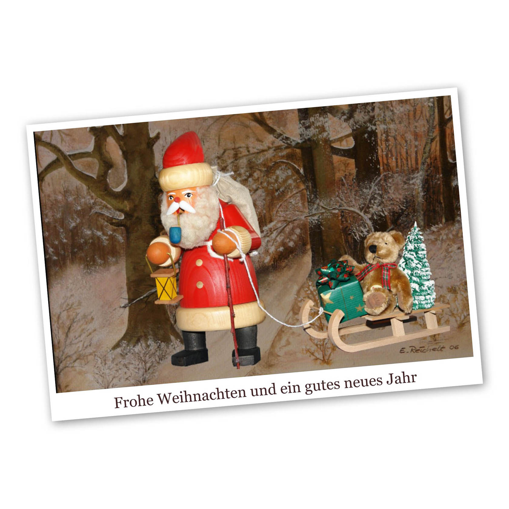 Christmas card with Santa Claus holding a lantern and sack, accompanied by a teddy bear on a sled with presents and a tree. Text: Merry Christmas and a Happy New Year. im Dregeno Online Shop günstig kaufen