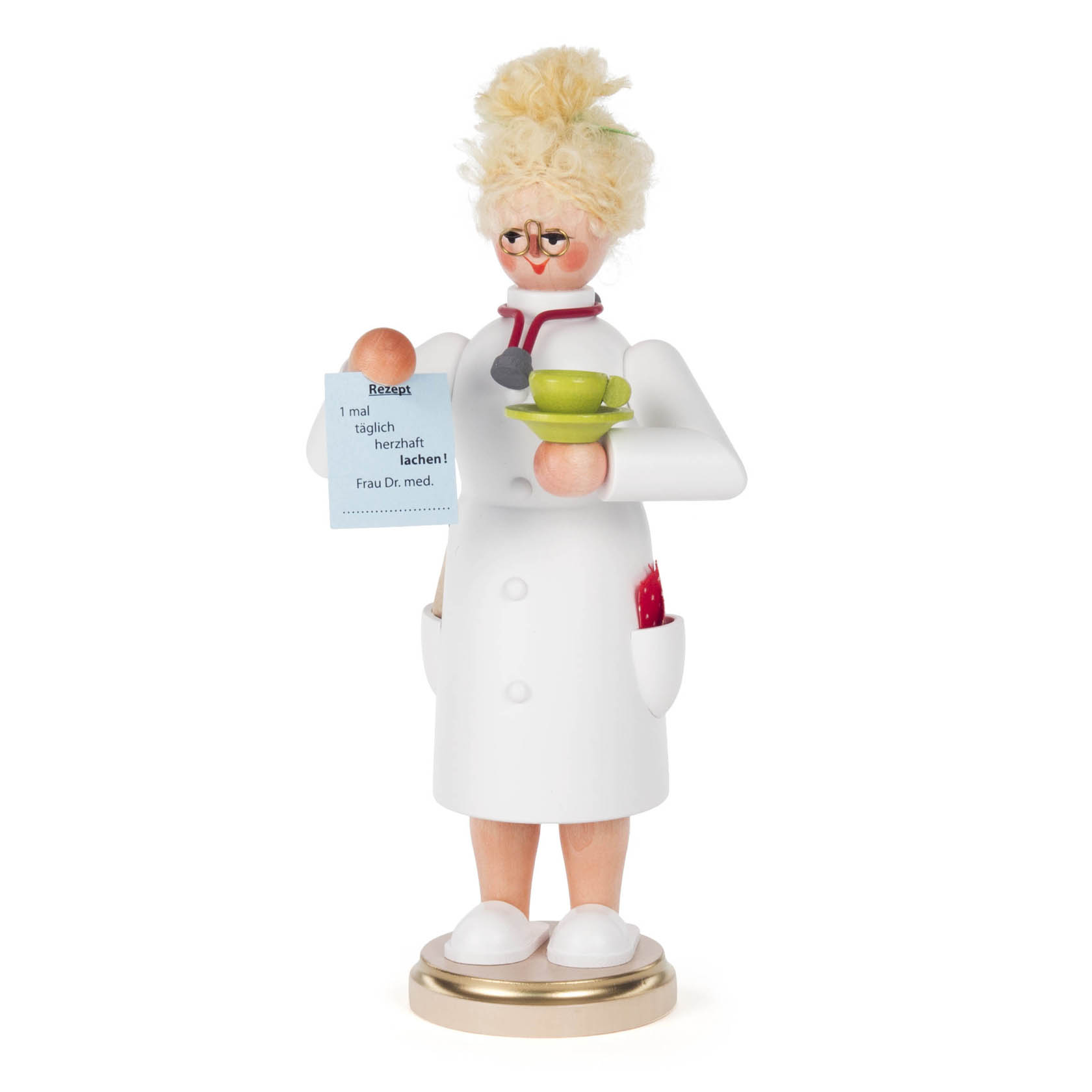 A wooden smoking figure of a female doctor with blonde hair, wearing glasses and a white lab coat, holding green cups and a prescription. im Dregeno Online Shop günstig kaufen