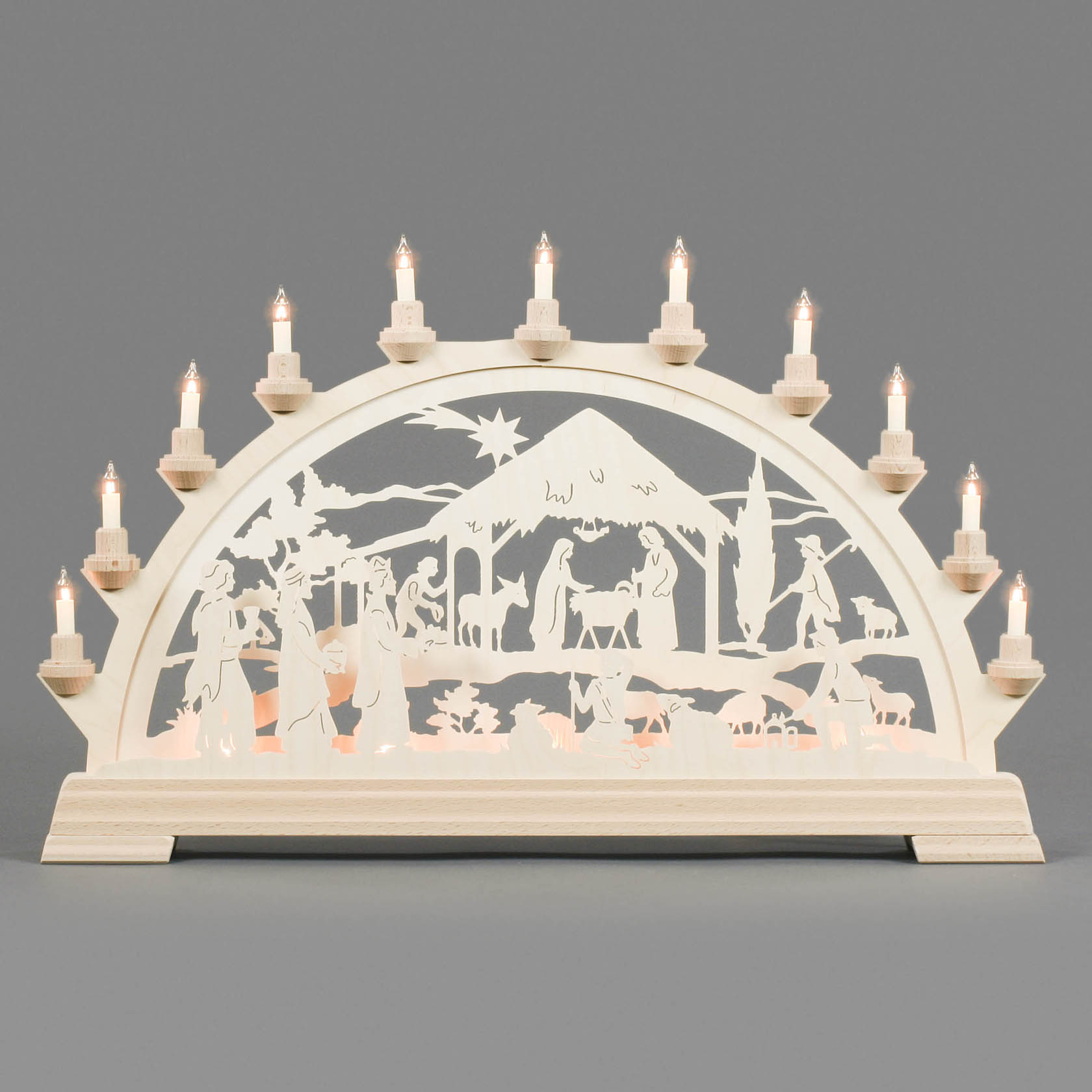Electric illuminated arch with cut-out nativity scene depicting the birth of Christ, featuring Mary, Joseph, the baby Jesus, shepherds, and animals.