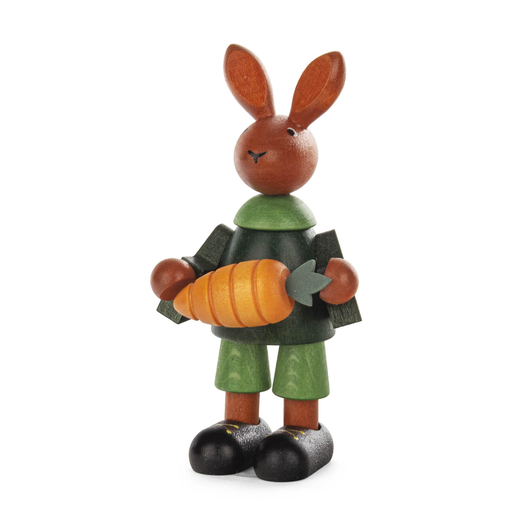 Holzfigur eines Osterhasen mit grüner Kleidung, der eine große orangefarbene Rübe in den Händen hält. im Dregeno Online Shop günstig kaufen