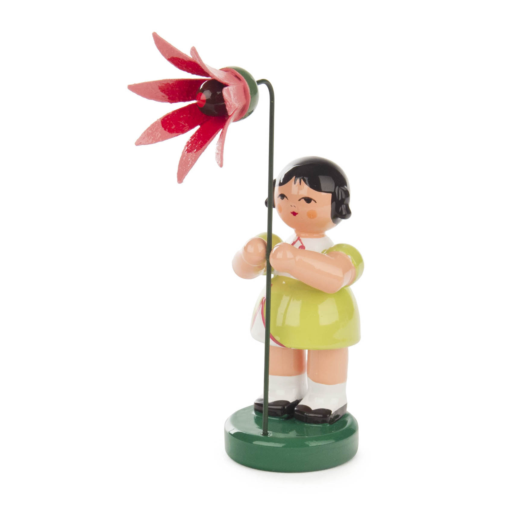 Figur eines Mädchens in lindgrünem Kleid mit schwarzem Haar, das eine große stilisierte Blume in Korallenfarbe hält. im Dregeno Online Shop günstig kaufen