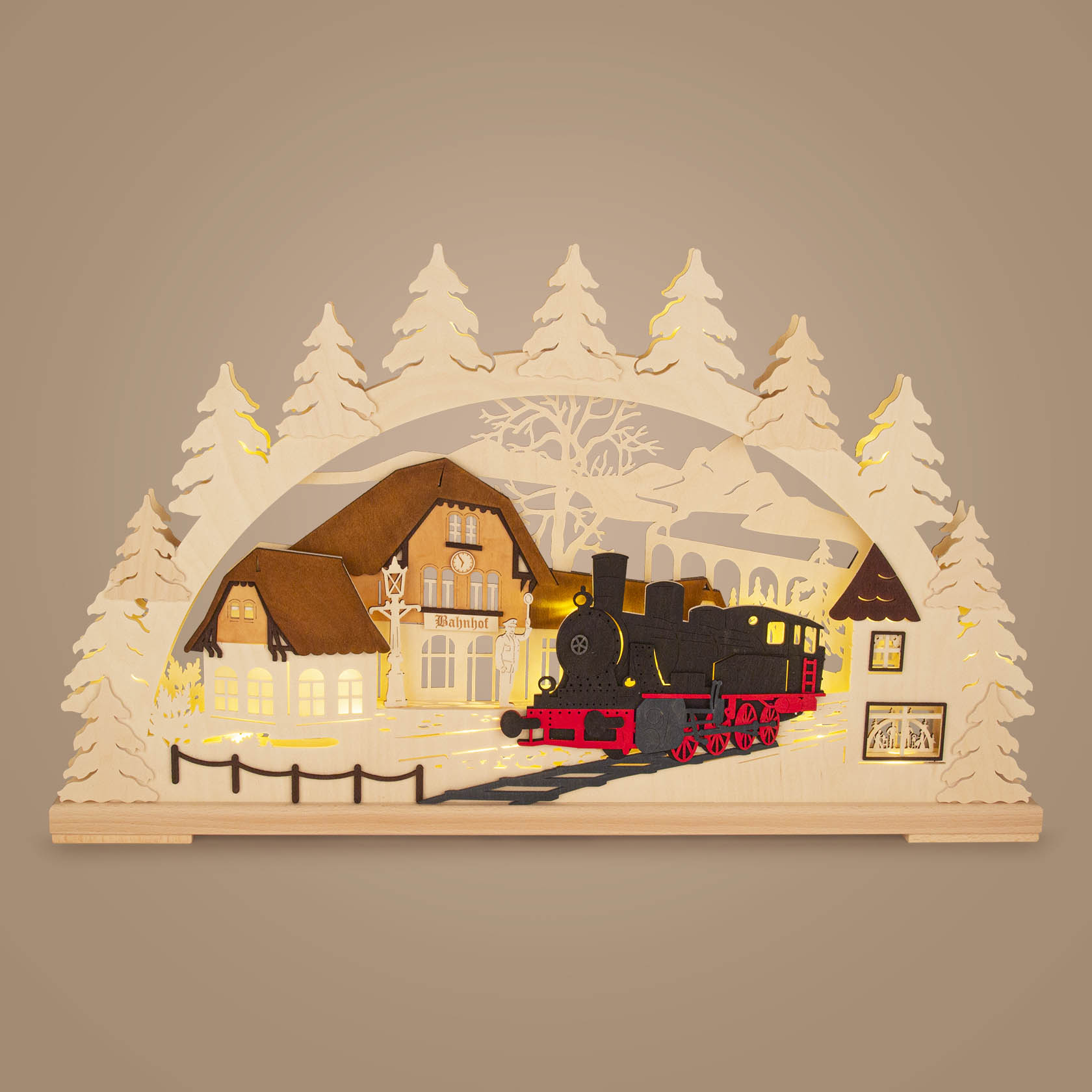 Wooden arch with LED lights depicting a train station scene with steam locomotive, surrounded by carved trees.
