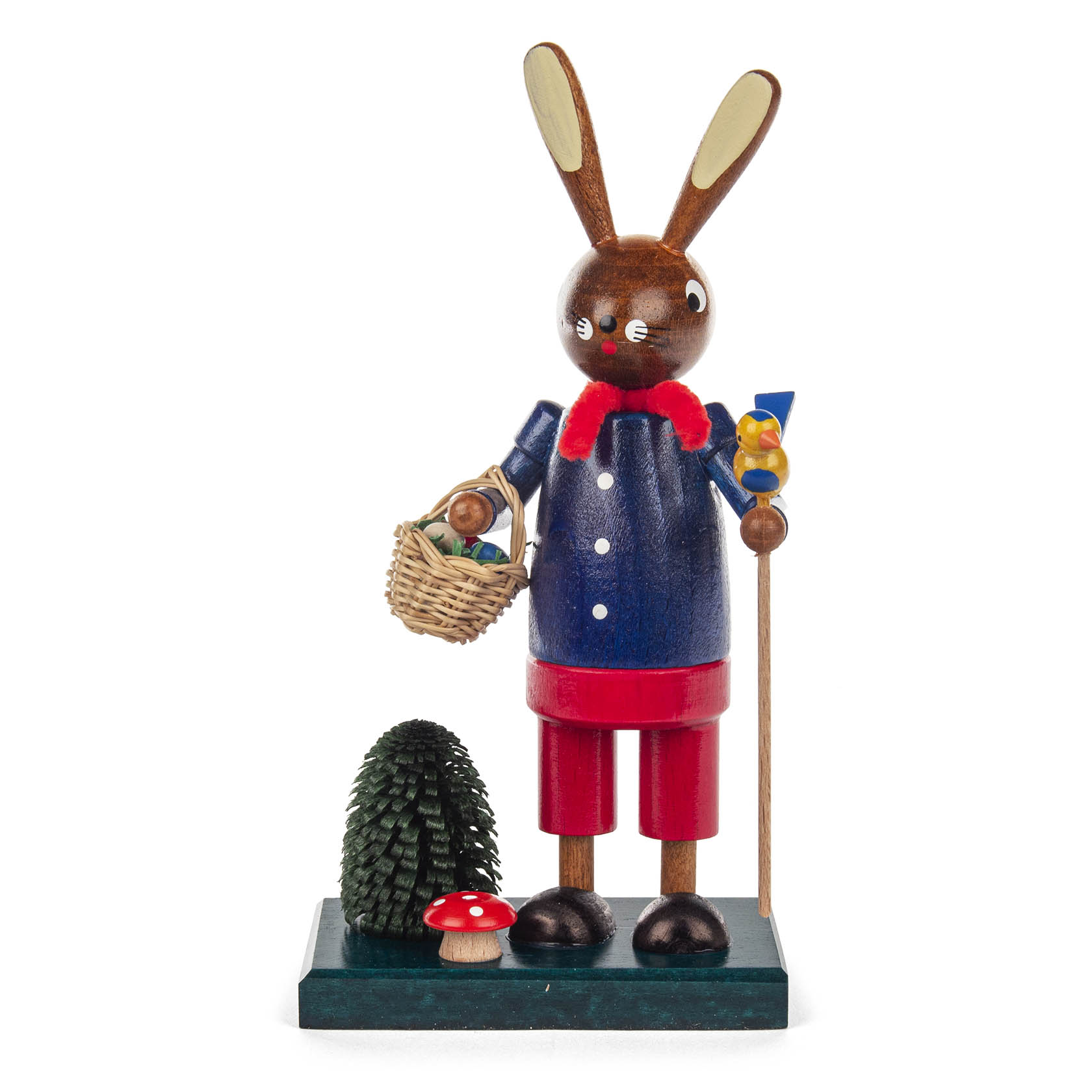 Holzfigur eines blauen Osterhasen mit roter Hose, der einen Stock hält und einen Korb mit Eiern trägt. Neben ihm steht ein kleiner, bemalter Pilz. im Dregeno Online Shop günstig kaufen