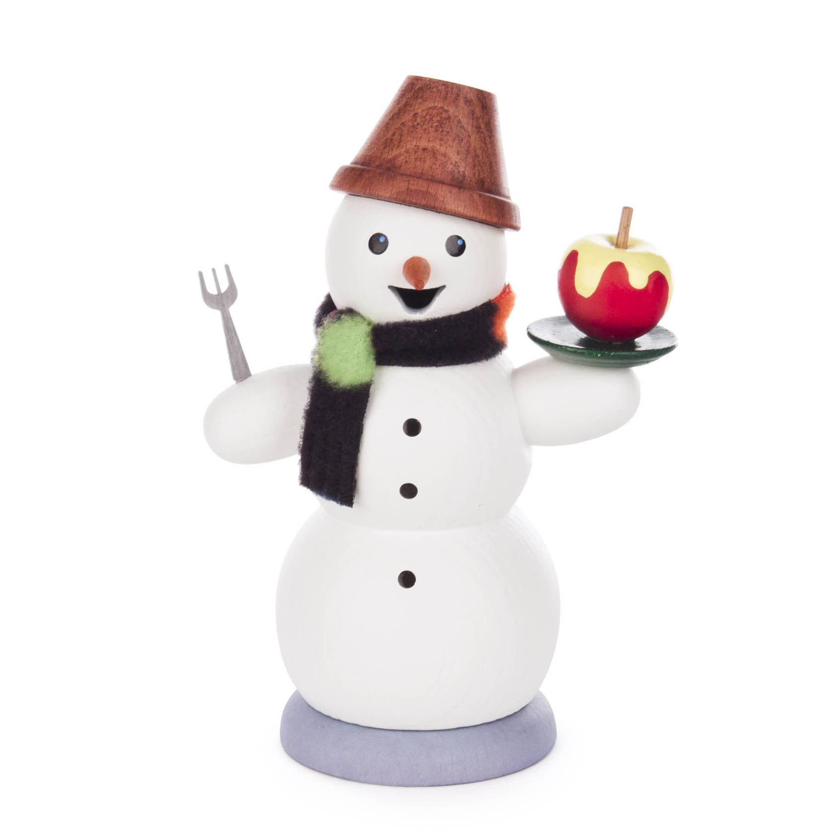 Wooden snowman incense smoker holding a fork in one hand and a plate with a baked apple in the other, wearing a black and green scarf and a copper hat.