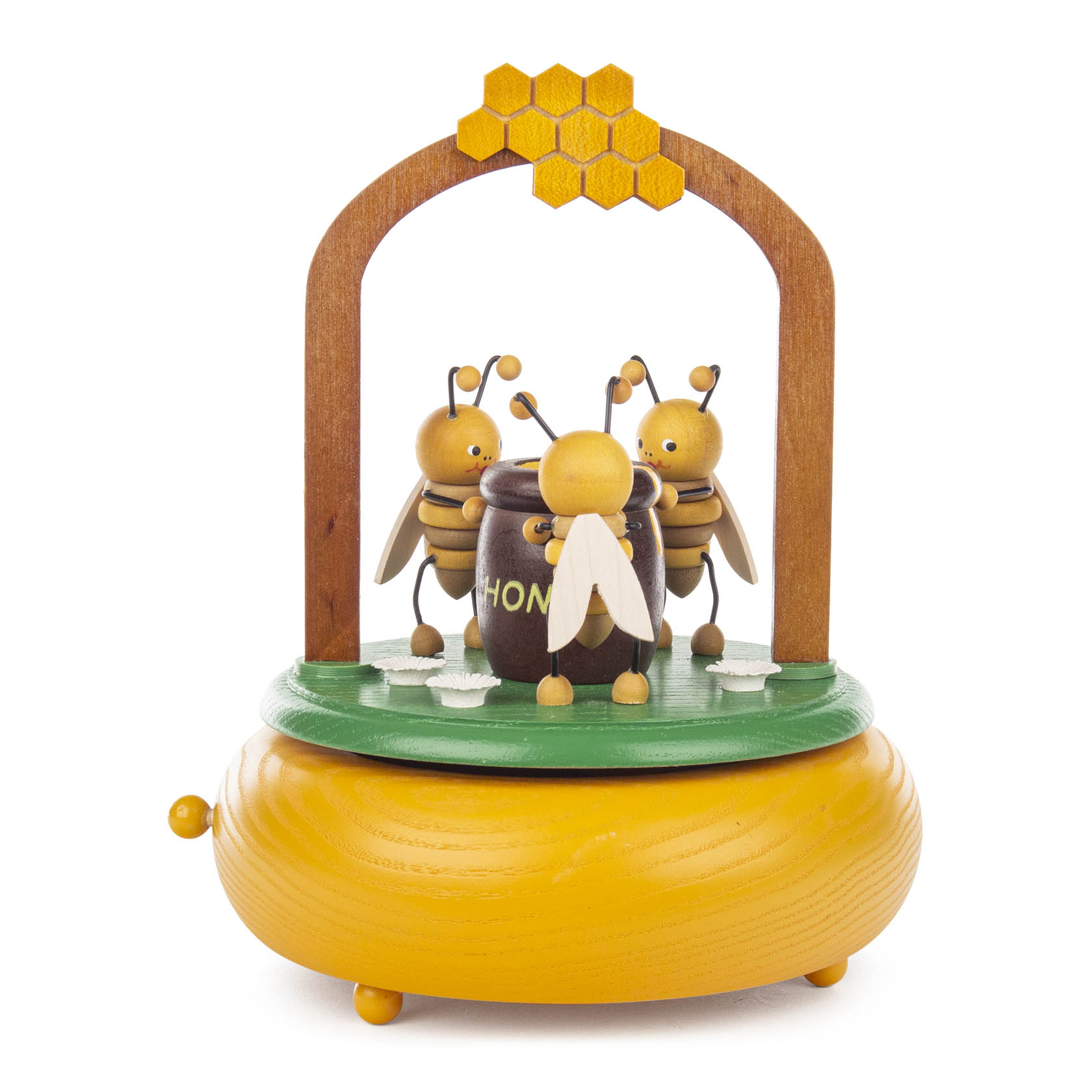 Holzspieldose in Form einer Bienenwiese mit drei Bienenfiguren und einem Honigtopf, dekoriert mit einem Holzaufbau mit Wabenmuster. im Dregeno Online Shop günstig kaufen