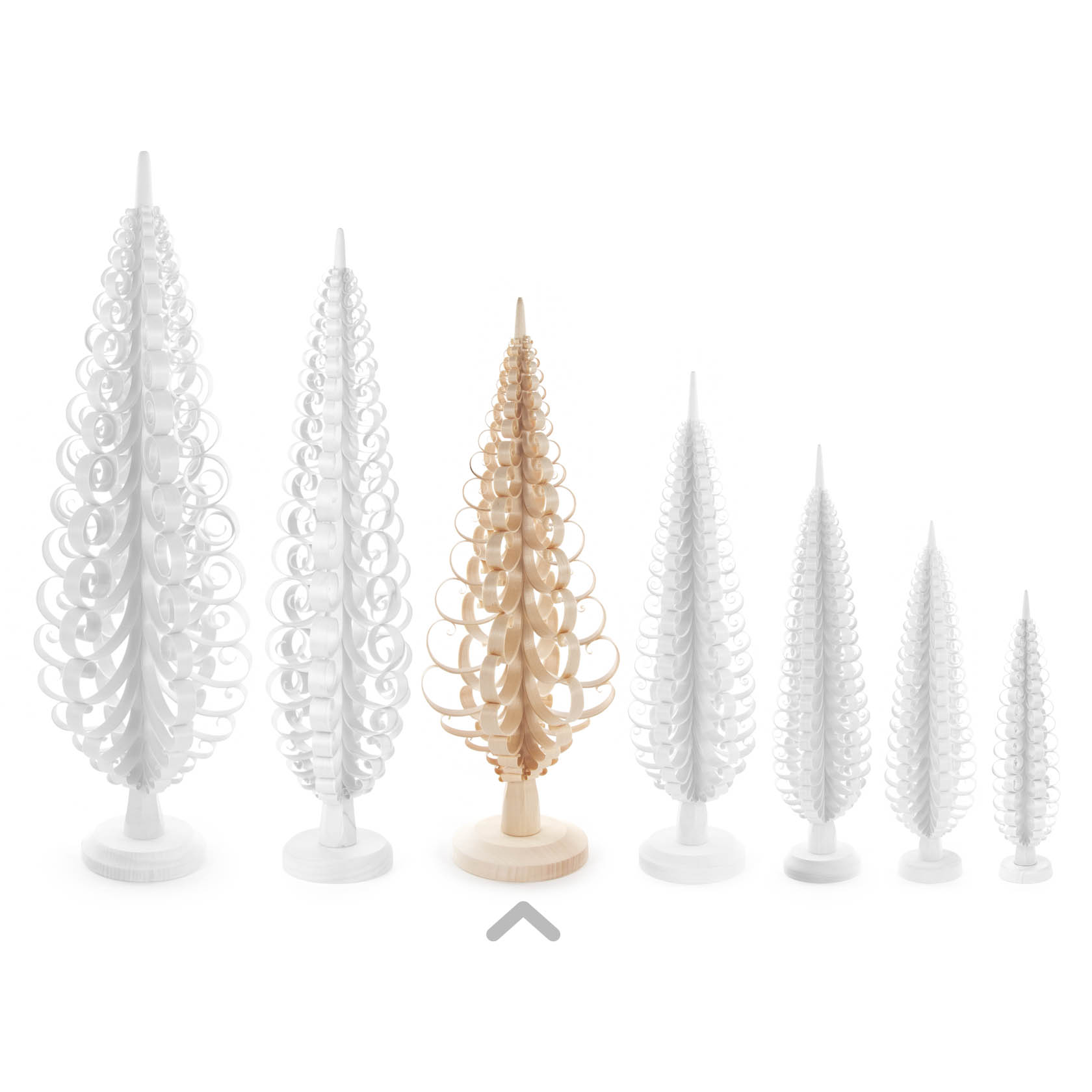 A set of spiral wooden trees in varying sizes, with one natural-colored tree in the middle surrounded by white trees.