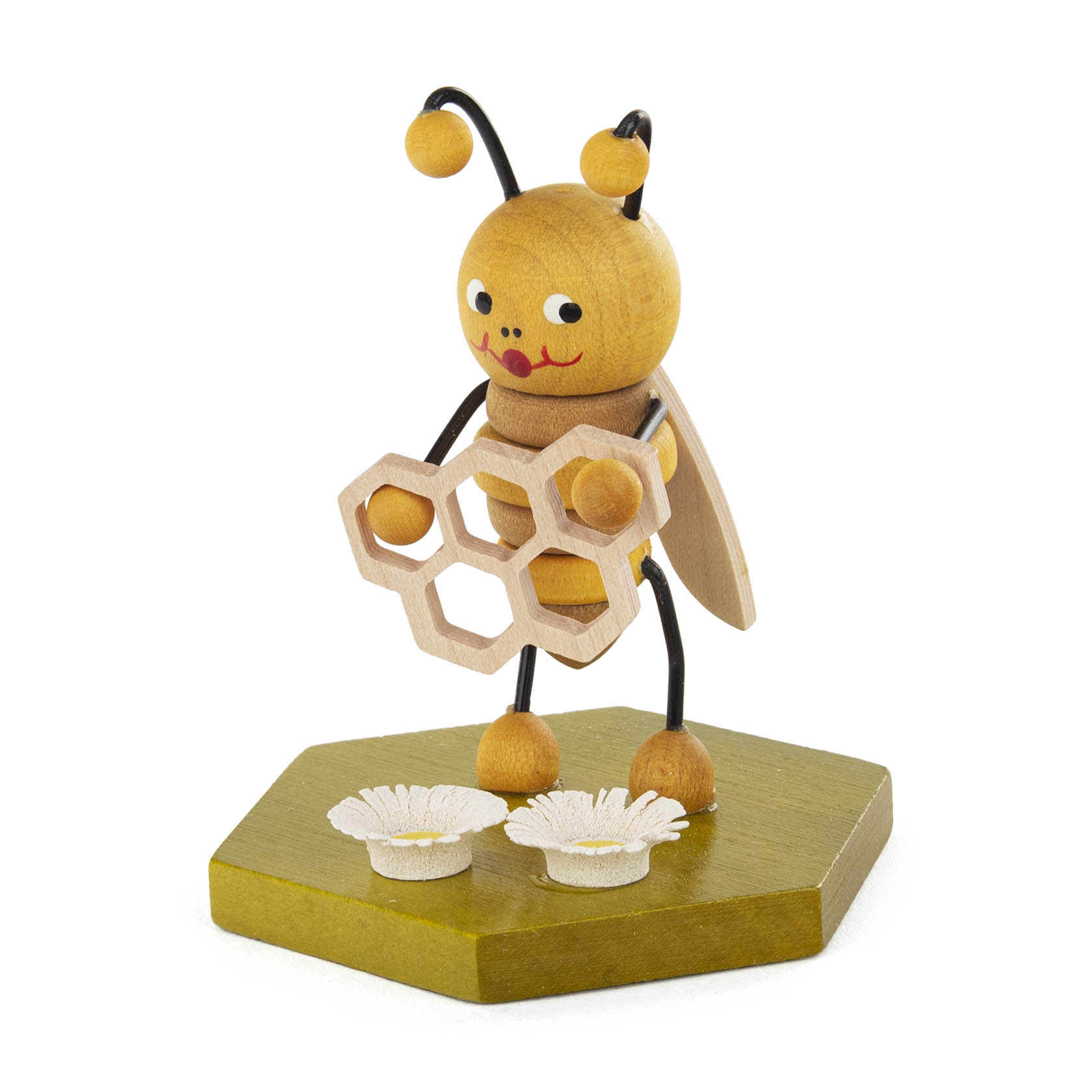 Holzfigur in Form einer fröhlichen, gelben Biene hält eine sechseckige Honigwabe. Vor der Biene liegt eine kleine weiße Blume. im Dregeno Online Shop günstig kaufen
