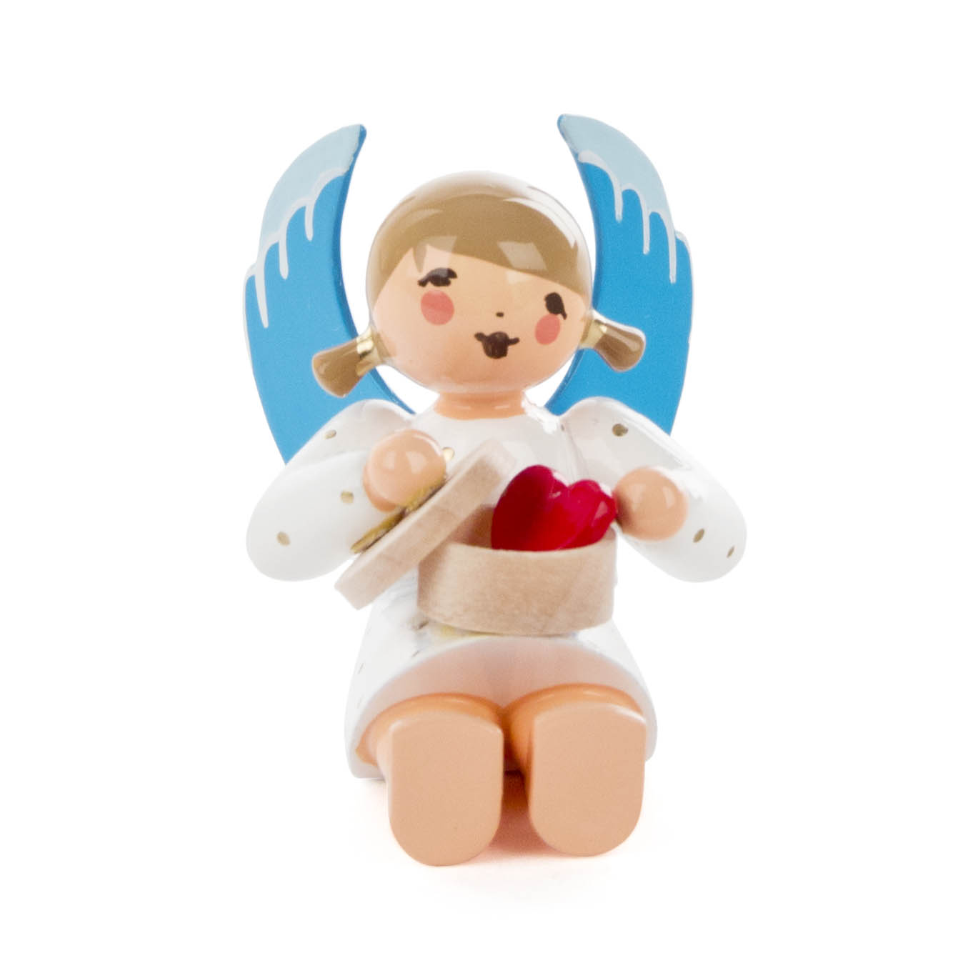 Wooden angel figure with blue wings, sitting and holding an open candy box containing a red heart.
