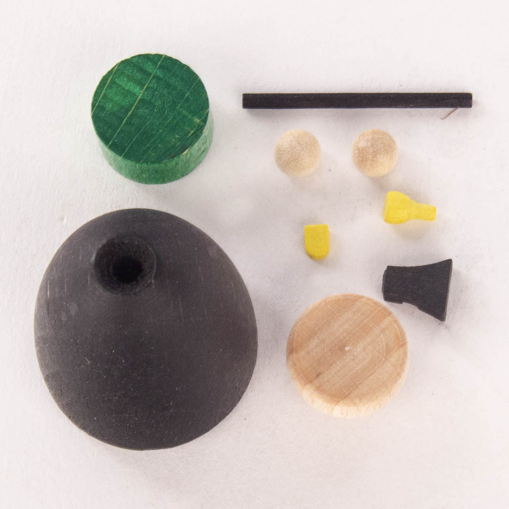 Craft kit components to assemble a miner figure approximately 5cm tall. Includes a round black base, green semicircle, black stick, wooden discs and small yellow handles.