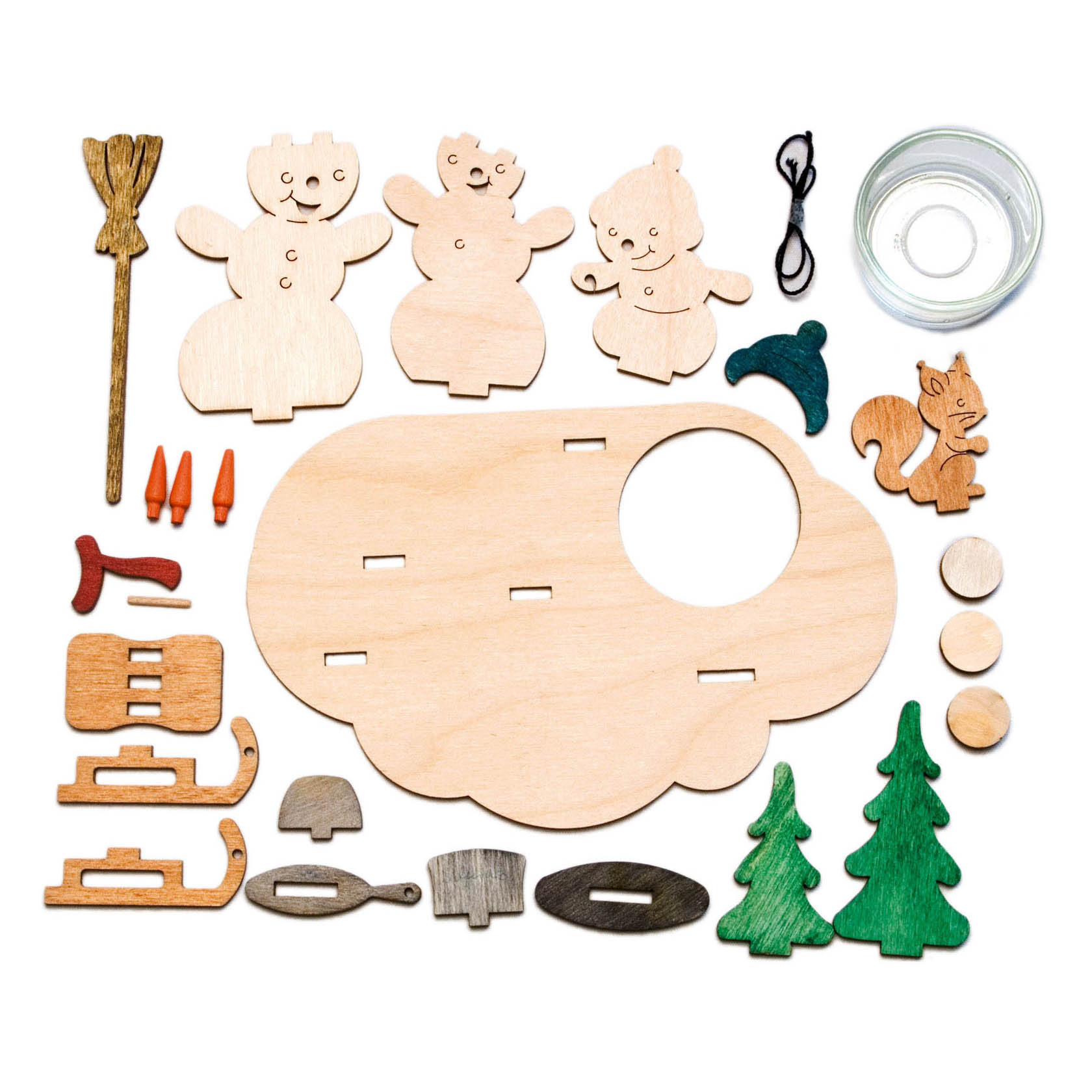 Wooden DIY tealight holder kit with snowman figures, a fox, trees, sleigh, broom, and small accessories, including a glass tealight holder.
