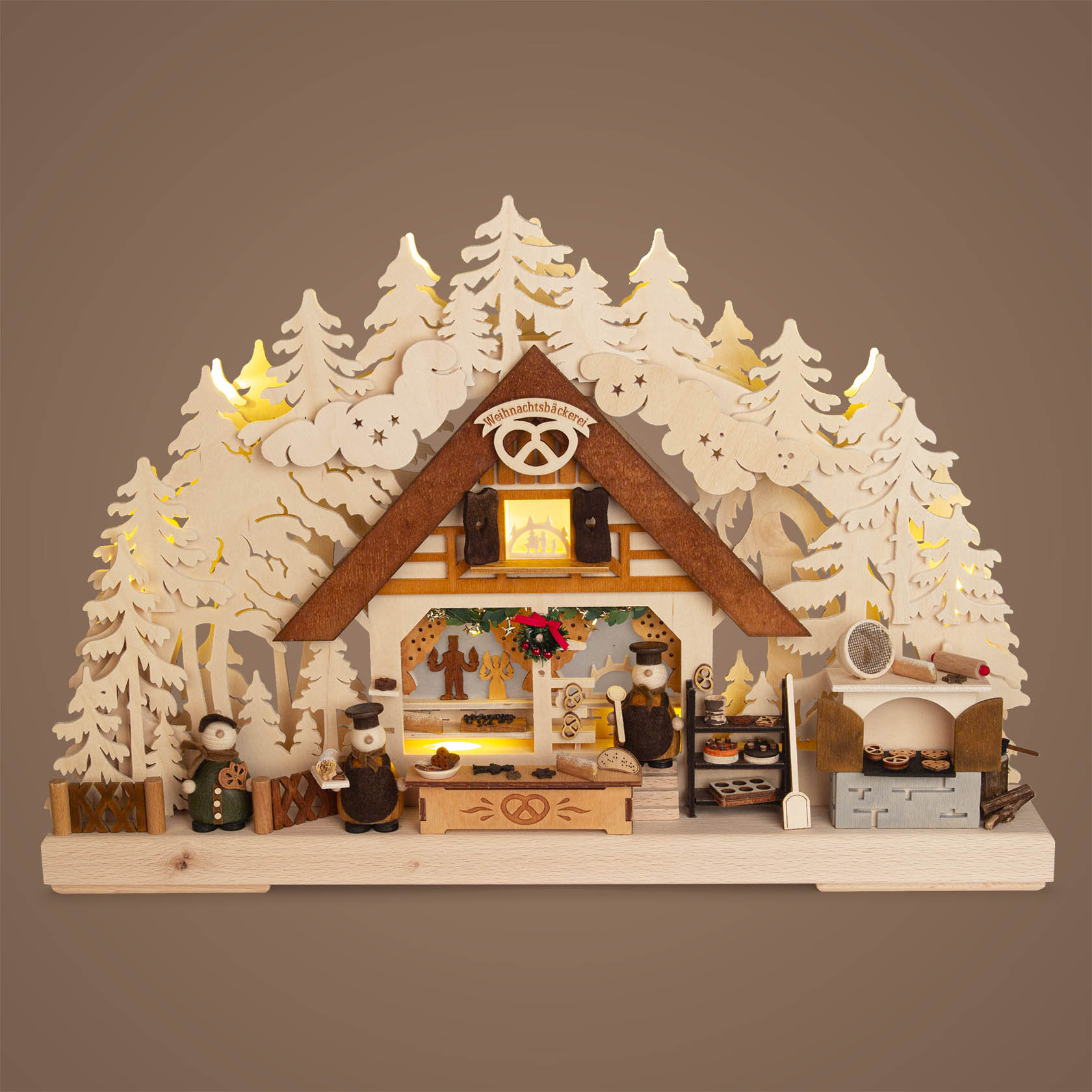 Wooden arch with intricate forest and bakery scene, featuring small figures working in a bakery setting with indirect electric lighting.