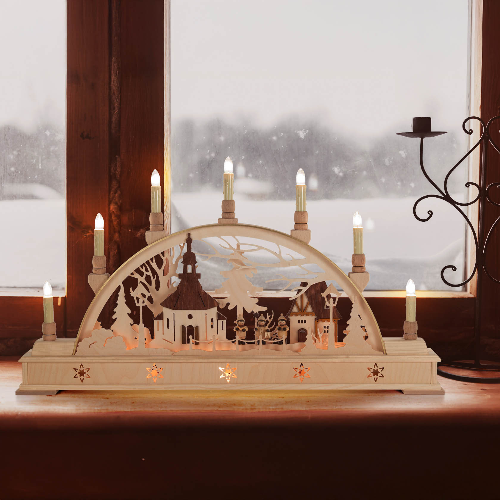 A wooden arch candle holder, Schwibbogen, depicting Seiffen Church and choir figures, electrically lit with multiple candles on a windowsill.