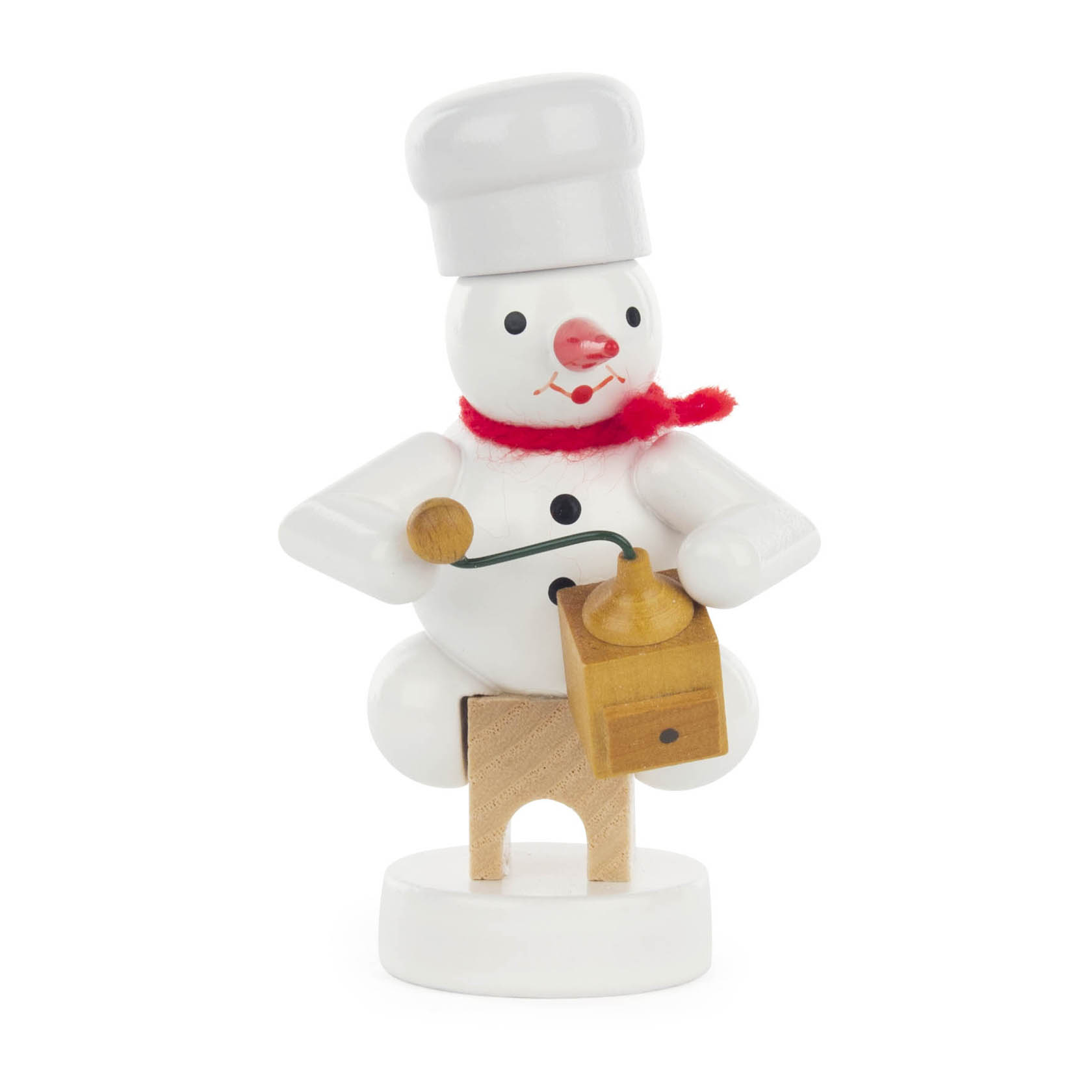 A cheerful snowman figure dressed as a baker with a chef's hat and red scarf, holding a wooden coffee grinder.