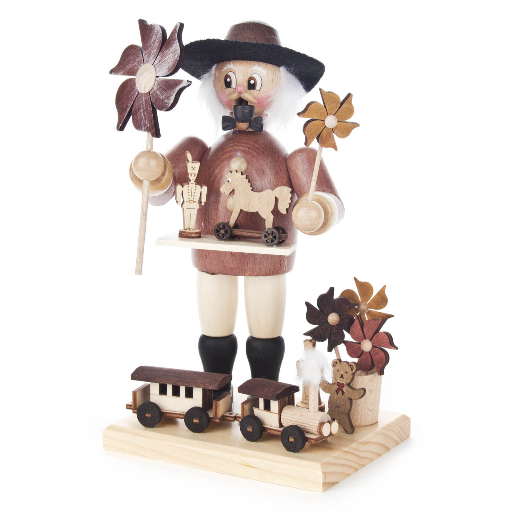 Holzfigur eines Spielzeughändlers mit Hut, der ein Steckenpferd und Spielzeugeisenbahn hält, begleitet von einem hölzernen Nussknacker und Blumen. im Dregeno Online Shop günstig kaufen
