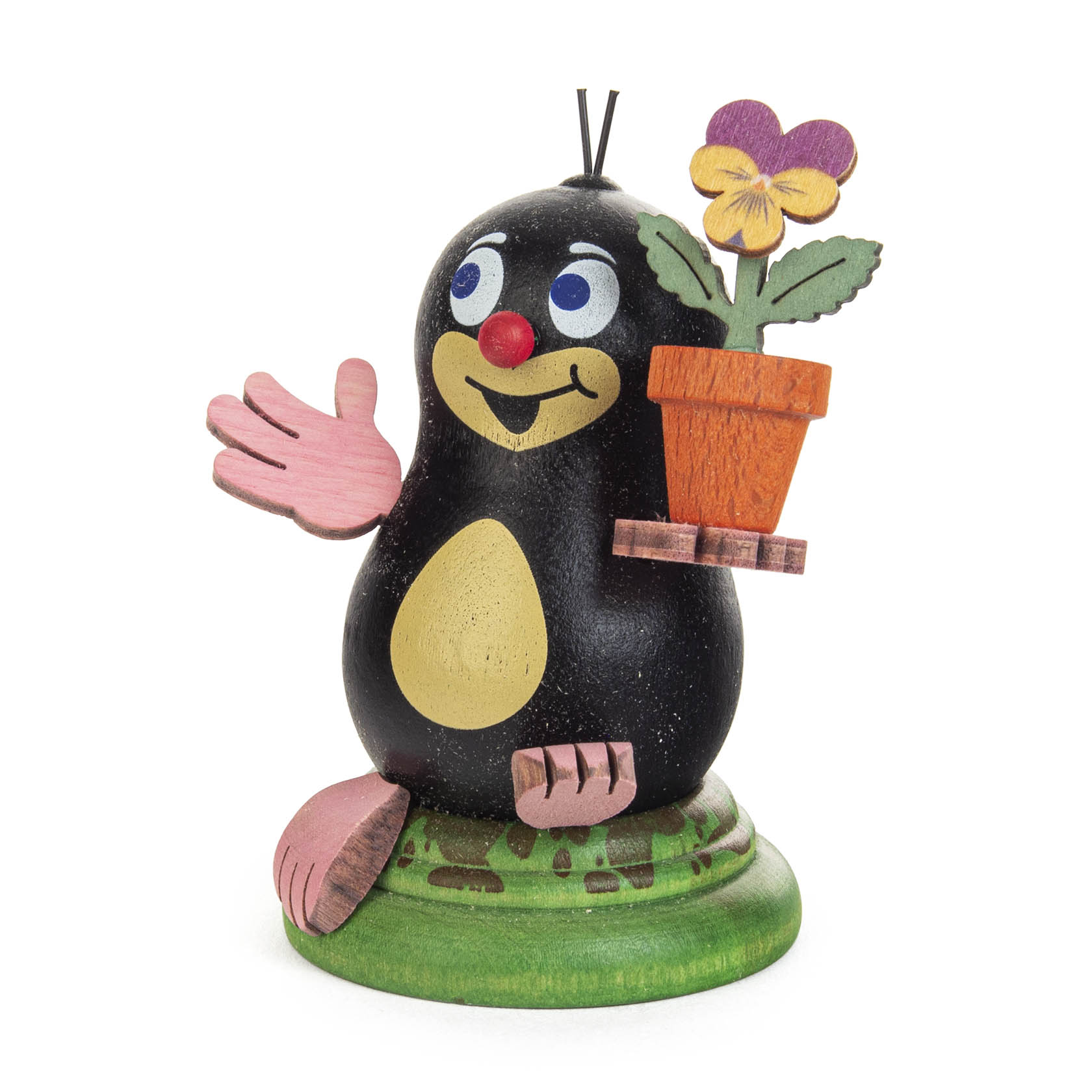 Casual cartoon-style figurine of a mole named Lilli, holding a flower pot with a purple flower, smiling with a raised pink paw. im Dregeno Online Shop günstig kaufen