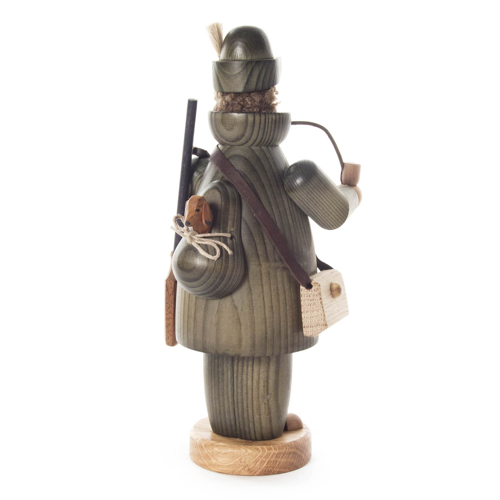 Holzfigur eines Jägers, mit Pfeife und Gewehr, trägt grünlichen Mantel.