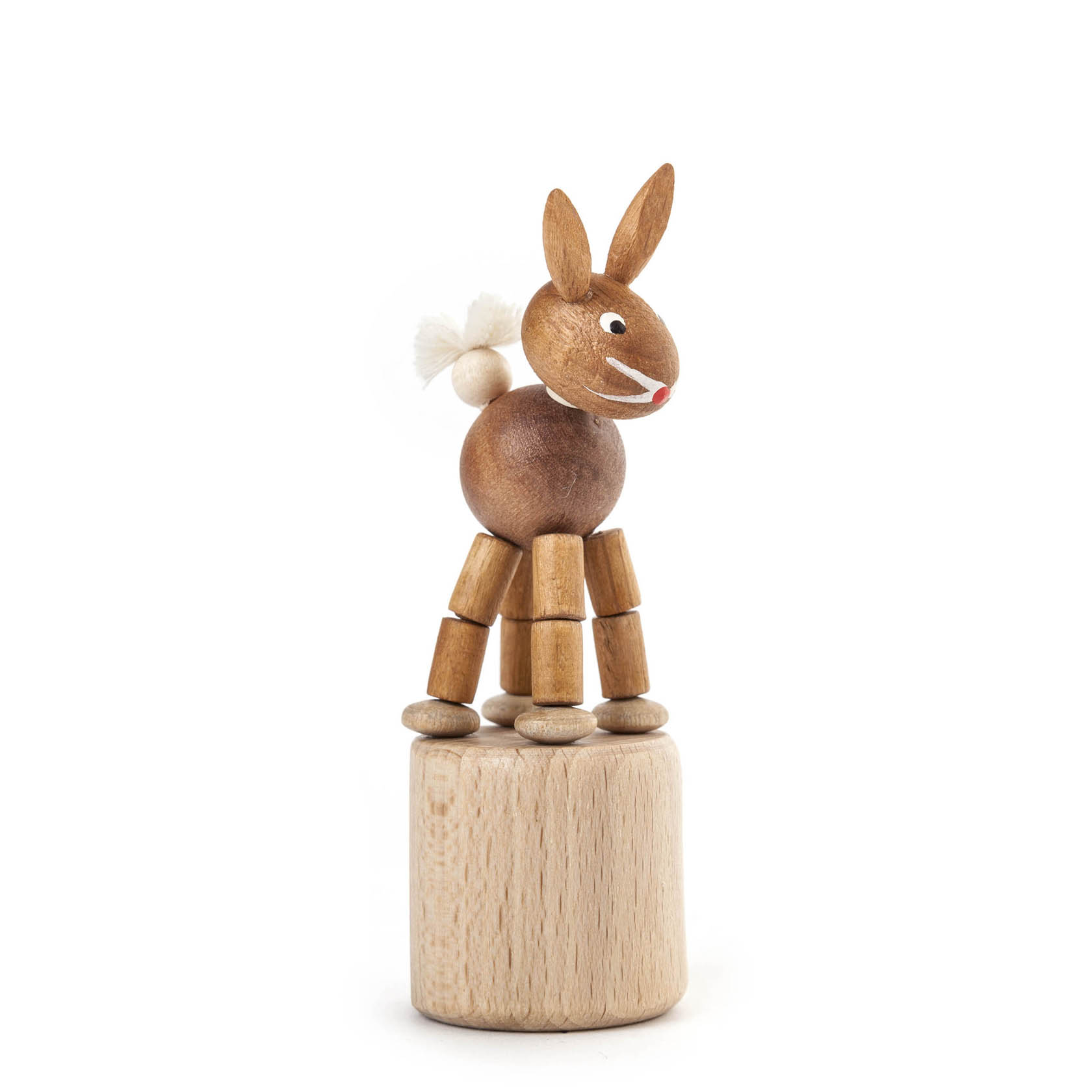 Ein hölzerner Wackeltier-Hase mit beweglichen Gliedern steht auf einem Sockel. Der Hase hat lange Ohren, ein weißes Schwänzchen und ein freundliches Gesicht. im Dregeno Online Shop günstig kaufen