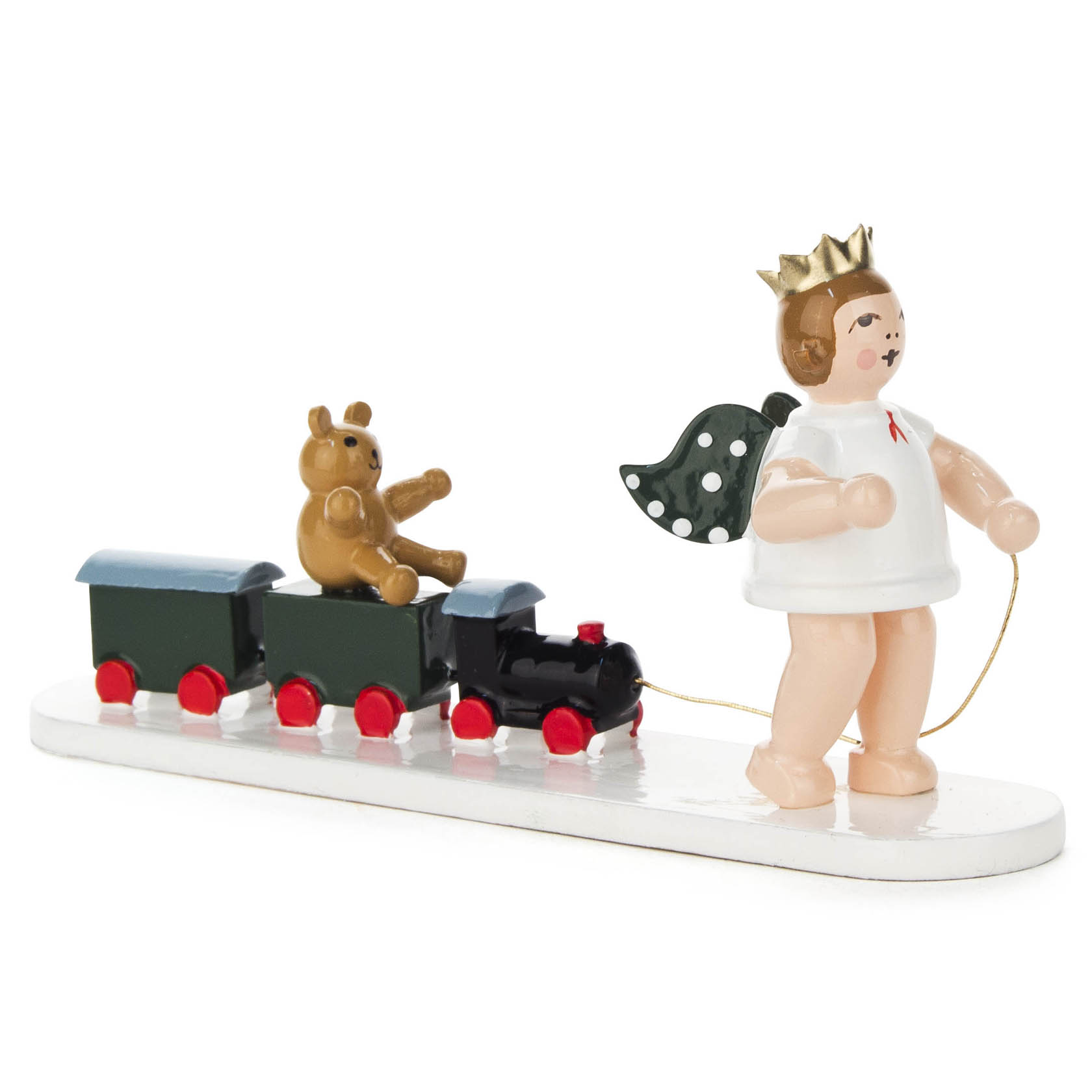 A wooden angel figure with a gold crown pulls a toy train with a teddy bear sitting on it. The angel has polka-dotted wings. im Dregeno Online Shop günstig kaufen