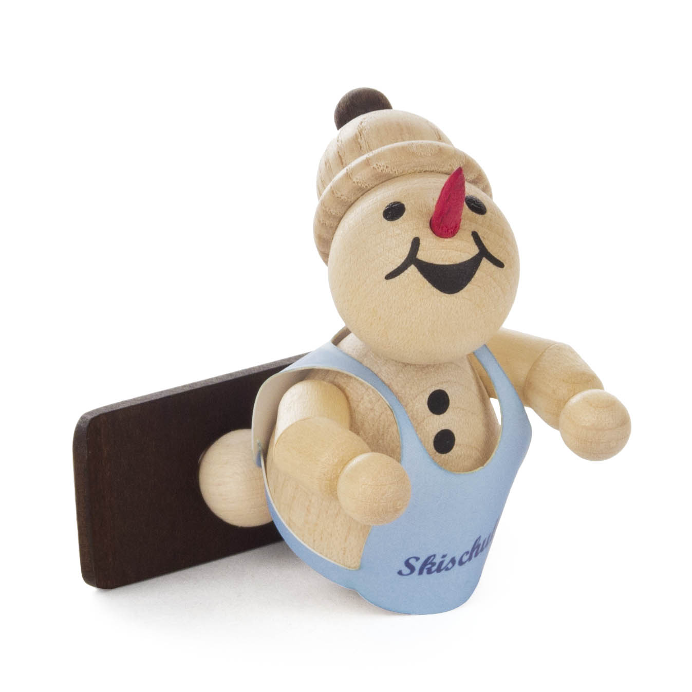 Holzfigur eines Schneemanns in Skikleidung mit Snowboard, lächelnd, liegt flach auf dem Bauch, trägt blaue Weste mit Schriftzug 'Skischule'. im Dregeno Online Shop günstig kaufen