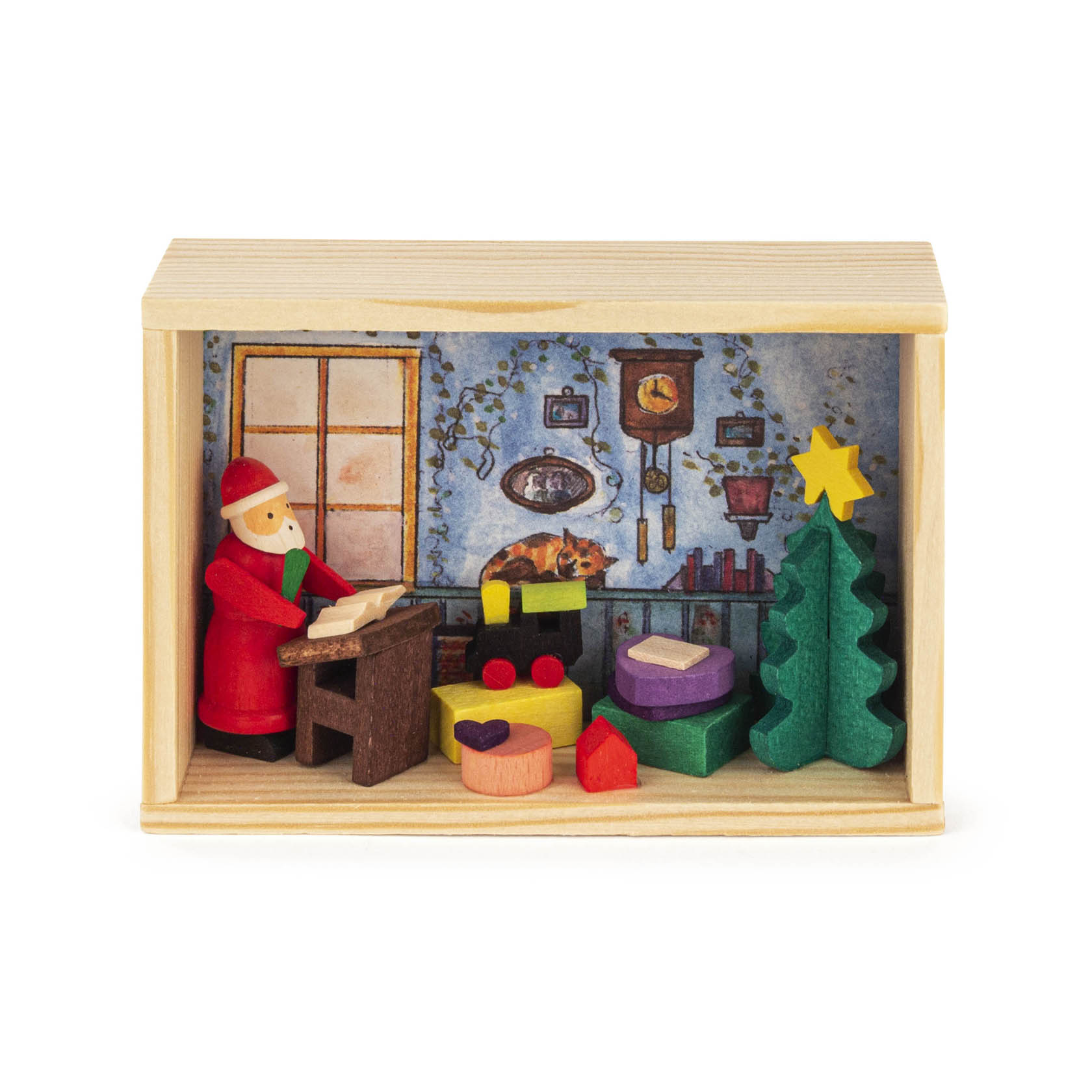 Ein Holzkästchen mit einer Szene, in der ein Weihnachtsmann an einem Tisch steht und einen Wunschzettel schreibt. Daneben ein Weihnachtsbaum und Geschenke.