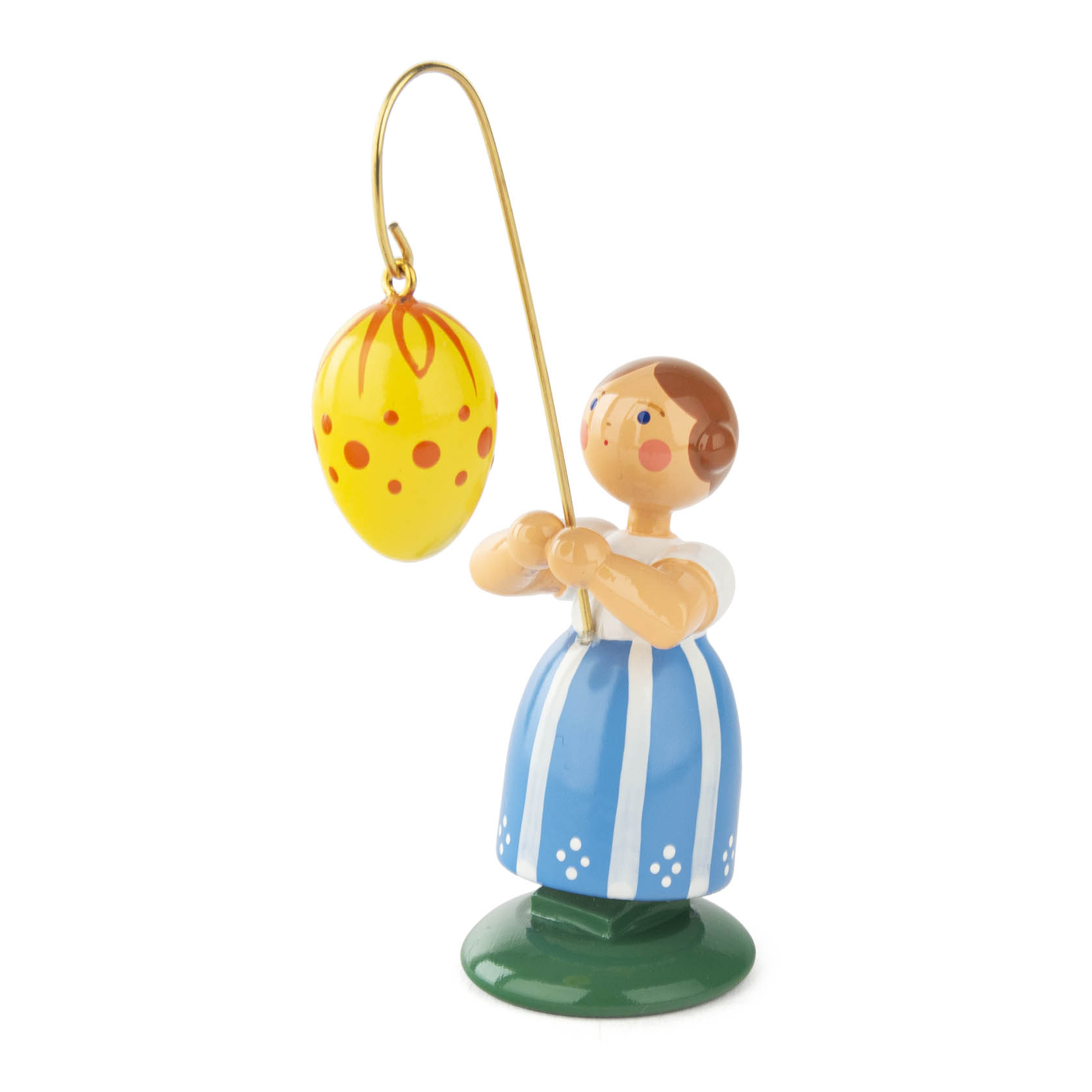 Holzfigur eines Mädchens in blau-weiß gestreiftem Kleid, das ein gelbes Osterei mit rotem Muster an einem goldenen Stab hält. im Dregeno Online Shop günstig kaufen