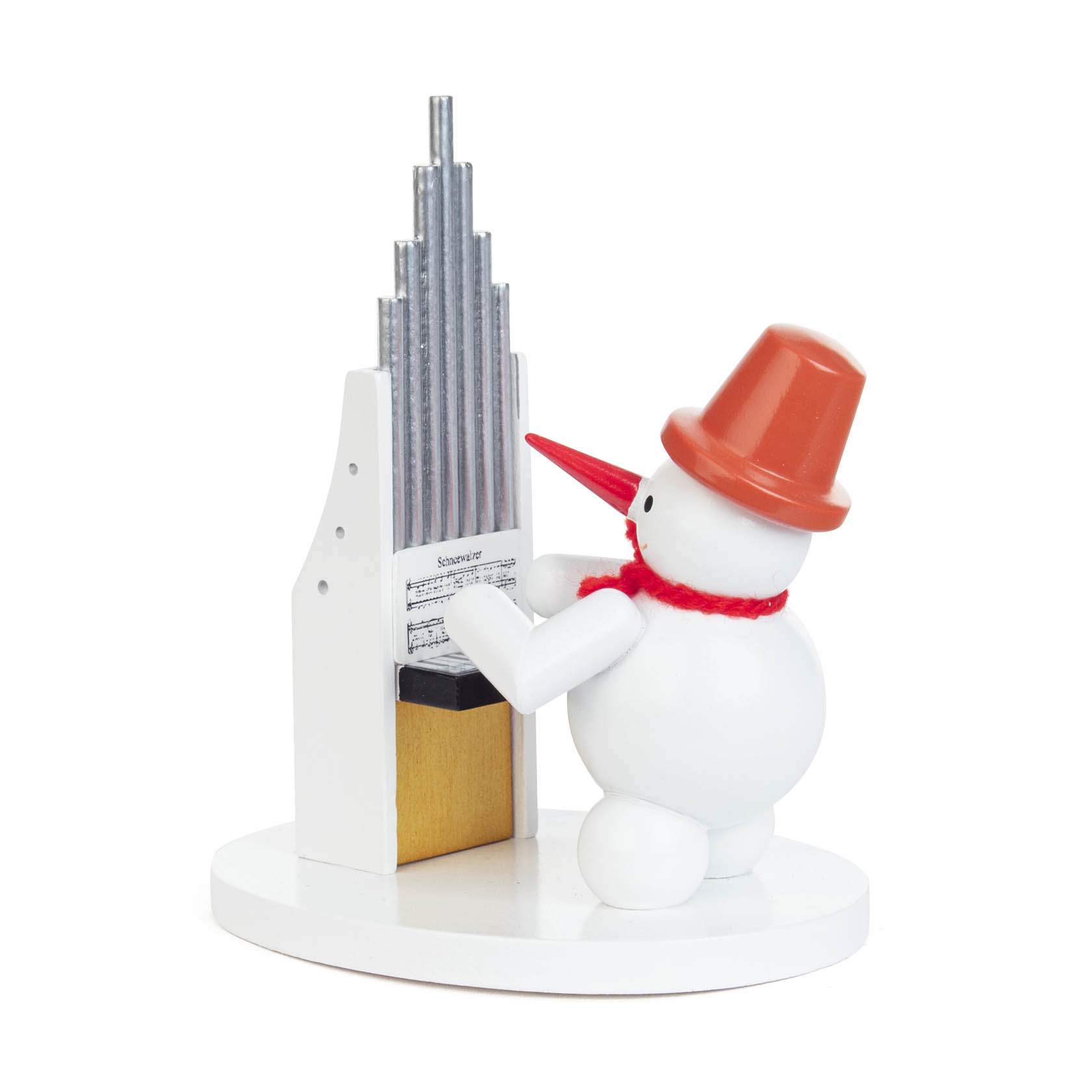 A small snowman figure with a red scarf and orange hat, playing a silver organ on a white base.